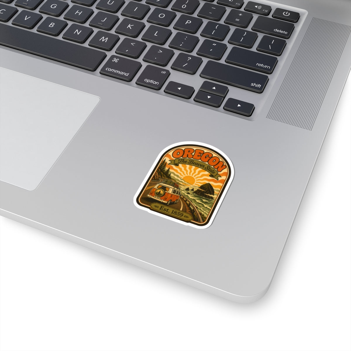 Oregon sunset van sticker with circular mountain and tree artwork, on a laptop lid
