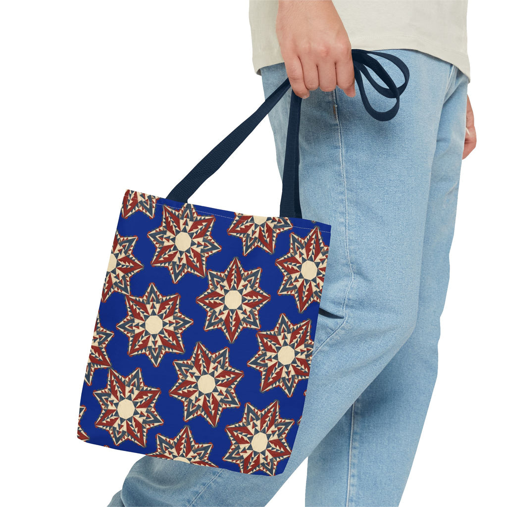 Starburst floral patterned tote bag with navy handles, red and cream geometric stars.