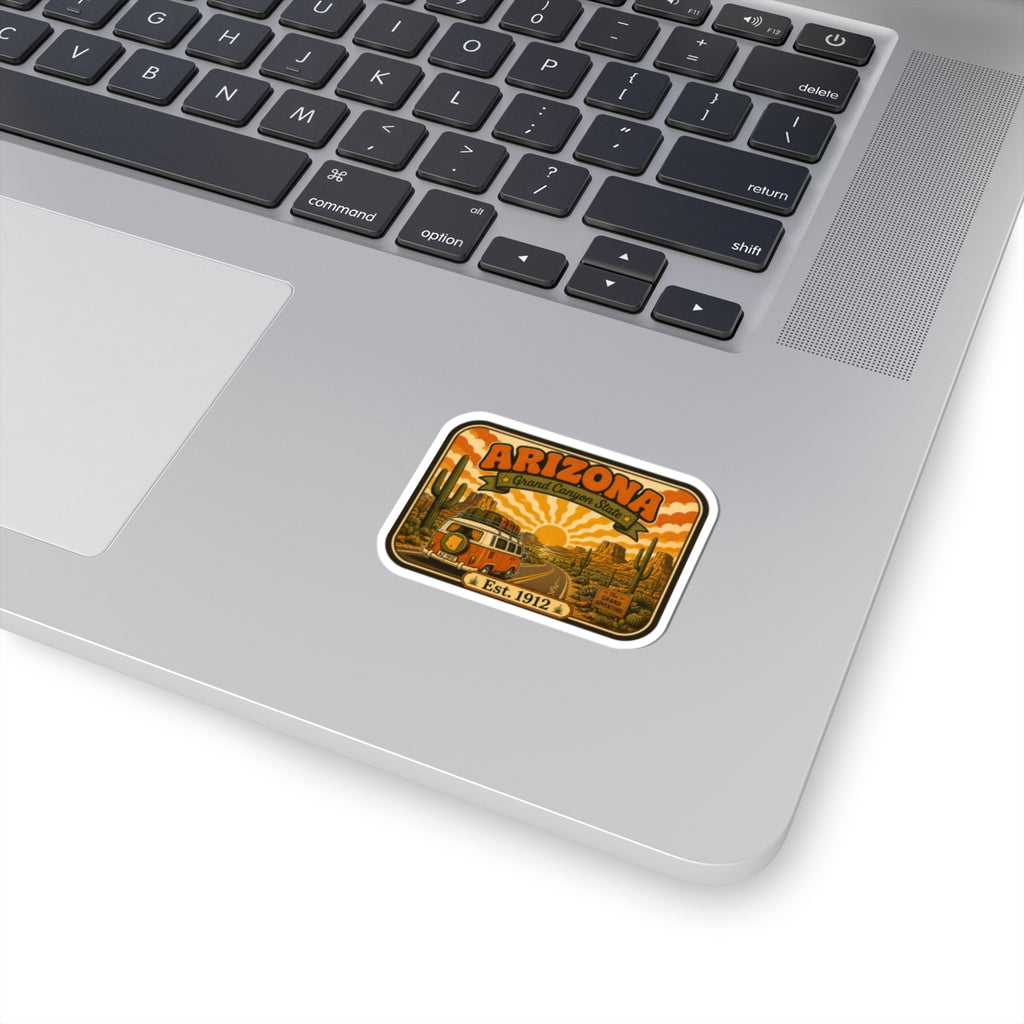 Rounded rectangular Arizona sticker with vintage camper, desert and sun graphic, white border