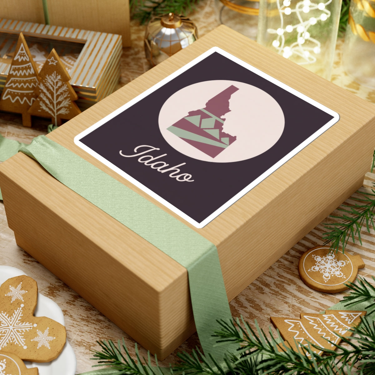 Idaho state silhouette sticker on a gift box, mauve square with white outline and 'Idaho'