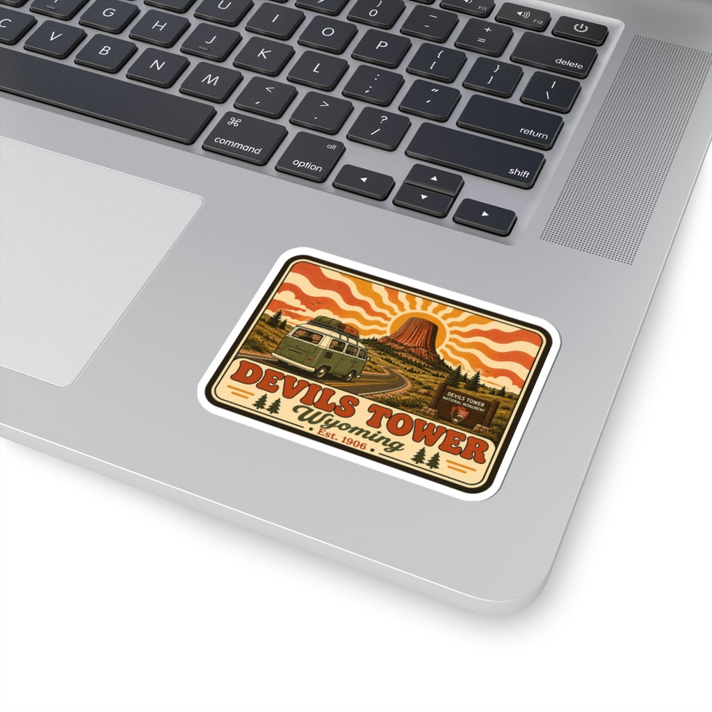Kiss-cut sticker with rounded white border: green camper, Devil’s Tower, and Wyoming lettering