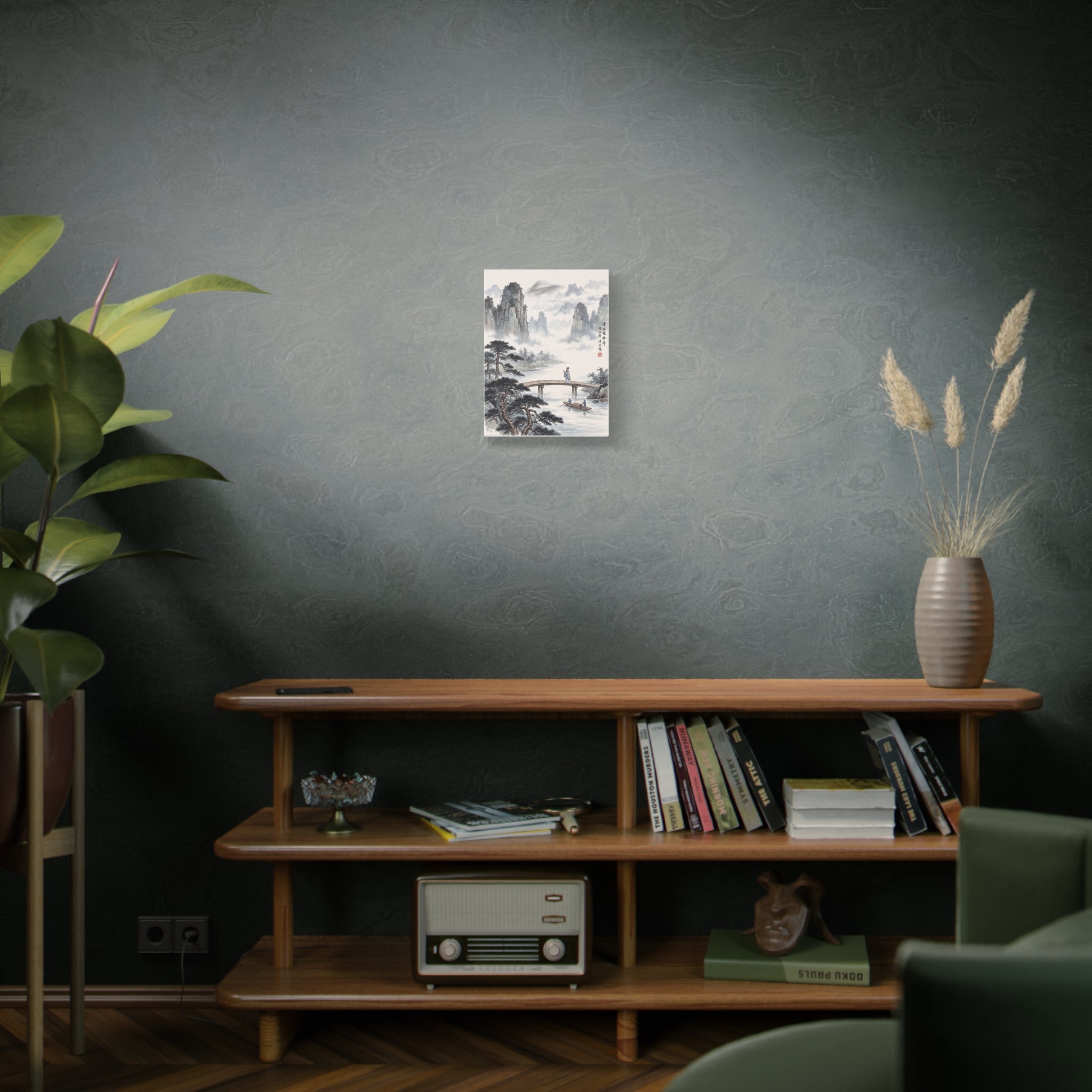 Framed landscape wall art print on a dark green wall with misty mountains and river bridge