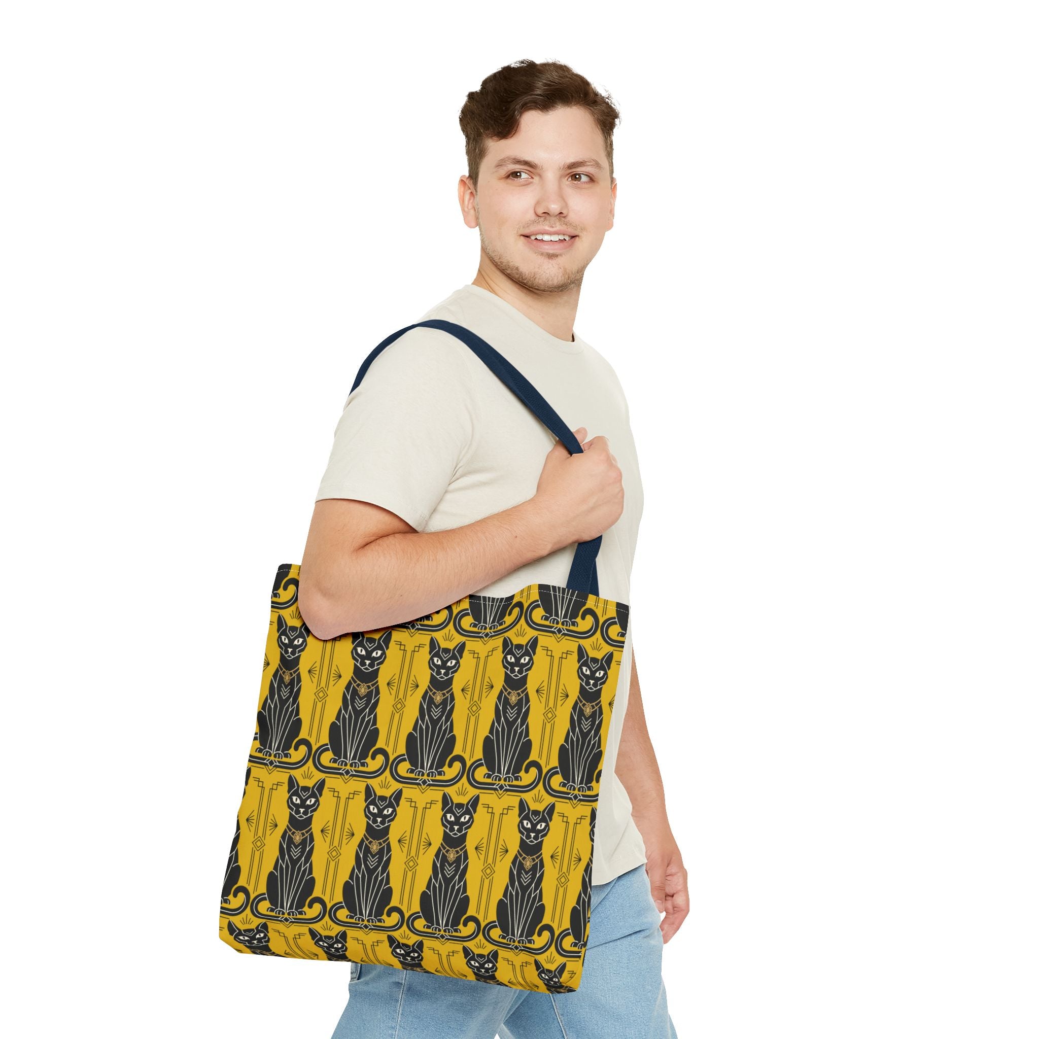 Yellow tote bag with black cat pattern carried on shoulder, navy strap