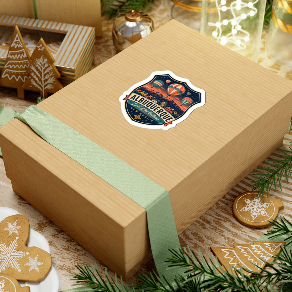 Luggage tag sticker on a wrapped box: Albuquerque badge with hot air balloons