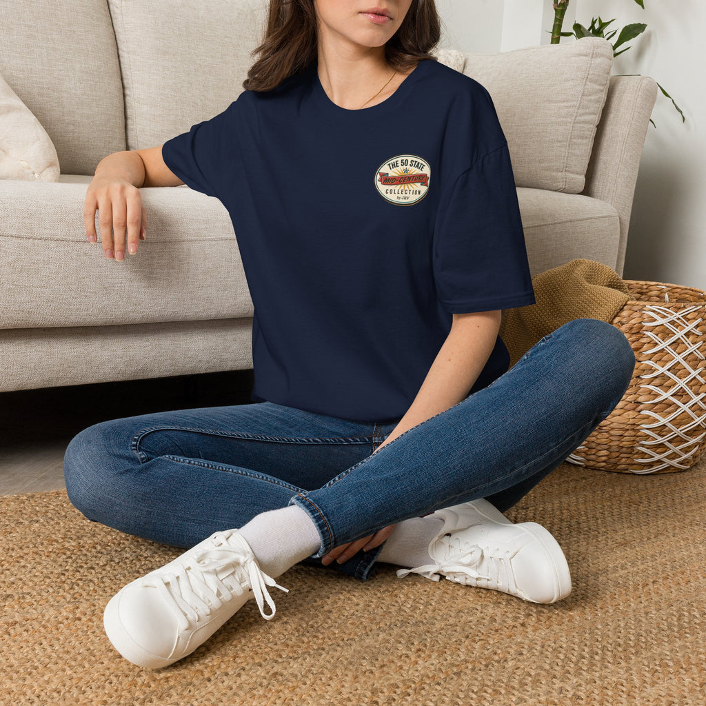 Navy crewneck T-shirt with round chest logo, model seated