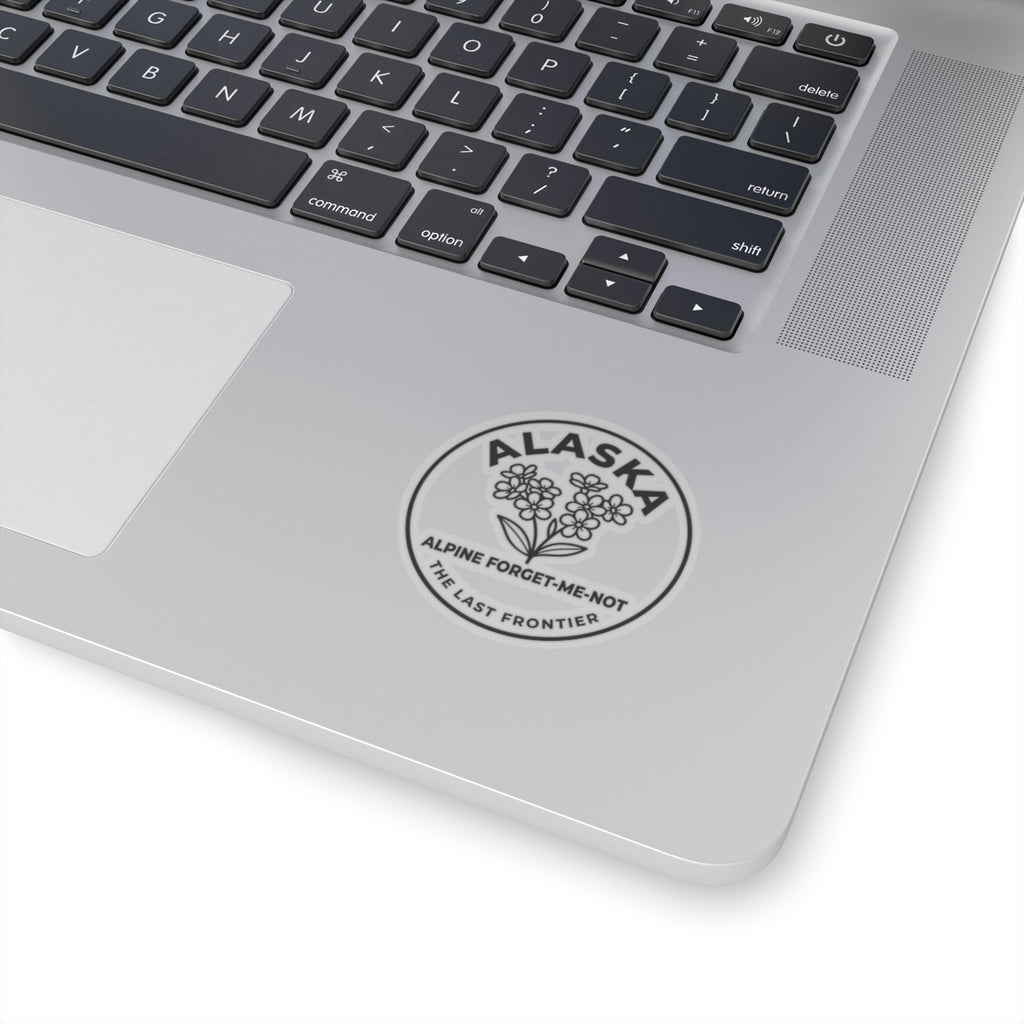 Alaska alpine forget-me-not vinyl sticker on a laptop palm rest, circular flower emblem