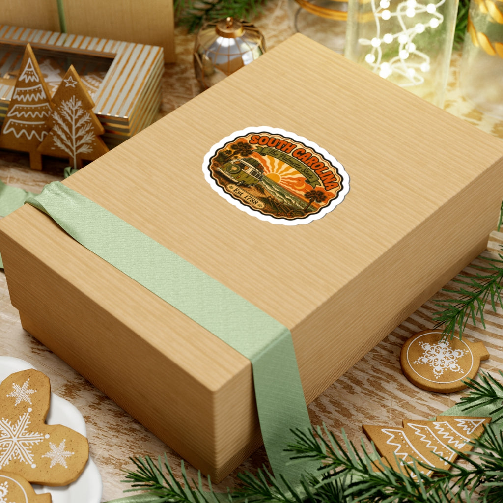South Carolina sticker on a wrapped gift box; camper, palms, sunset, The Palmetto State.