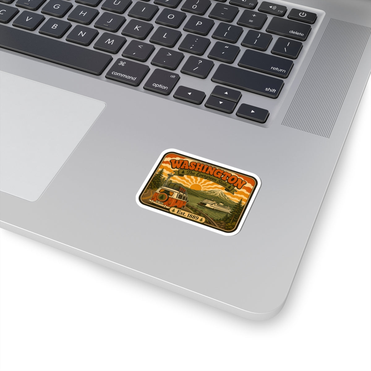Washington vintage road trip sticker with evergreen trees and sunset, kiss-cut on laptop