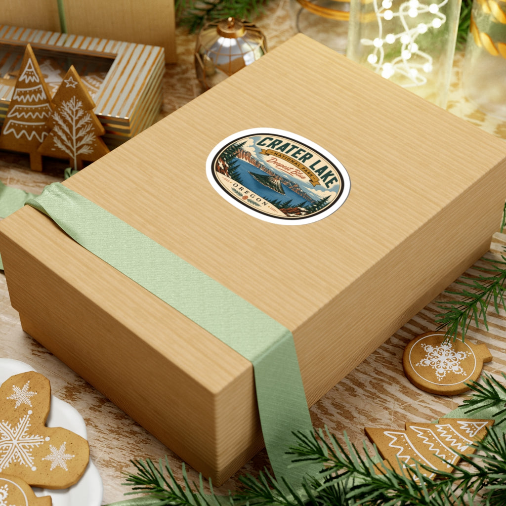 Round travel sticker on a gift box lid with green ribbon; Crater Lake and “Oregon” text.