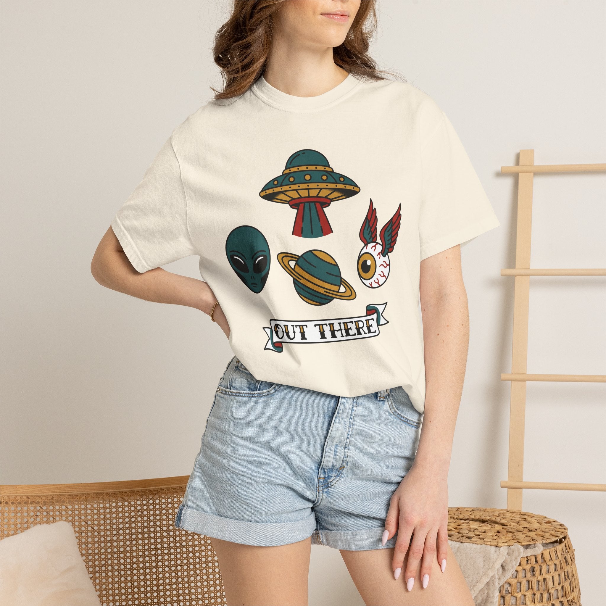 Cream crewneck T-shirt with alien, UFO, and “Out There” chest graphic