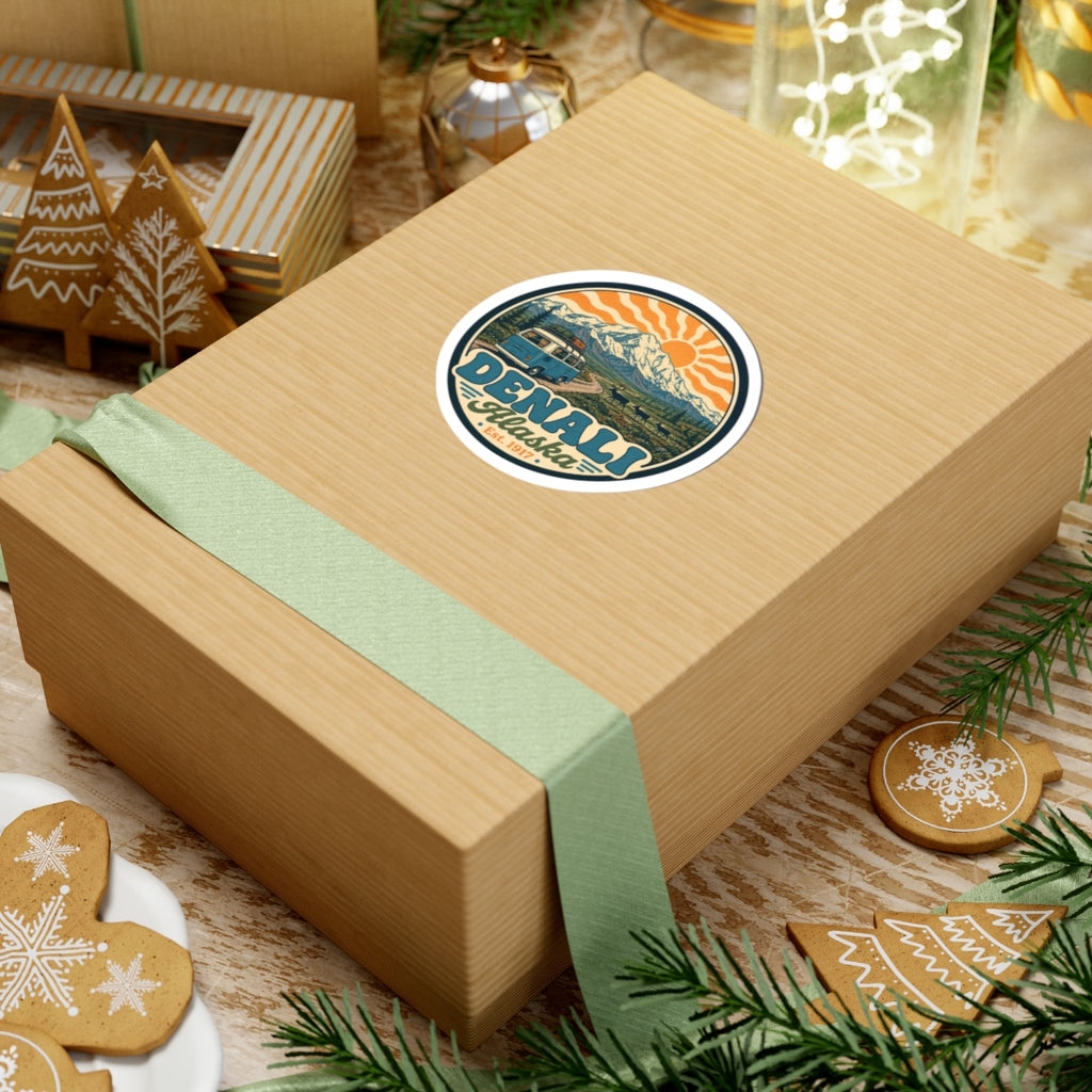 Circular Denali Alaska sticker on a gift box, mountain and sun rays with teal camper van