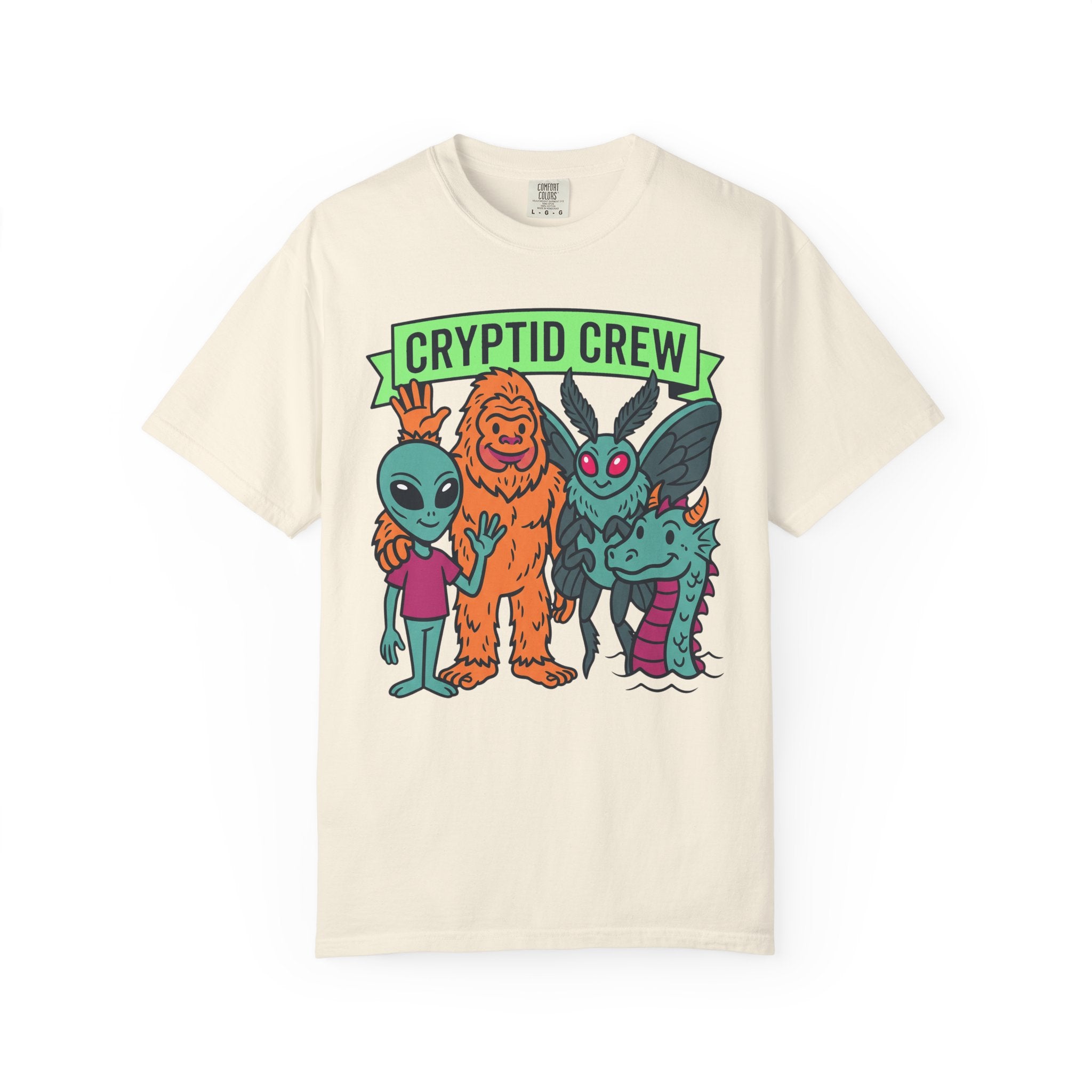 Ivory crew neck t-shirt with “CRYPTID CREW” cartoon cryptid group graphic