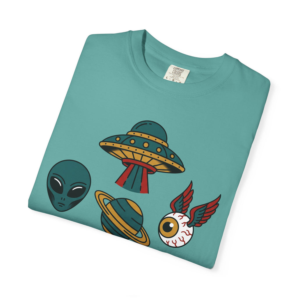 Teal crewneck T-shirt with alien UFO patchwork graphic on front.