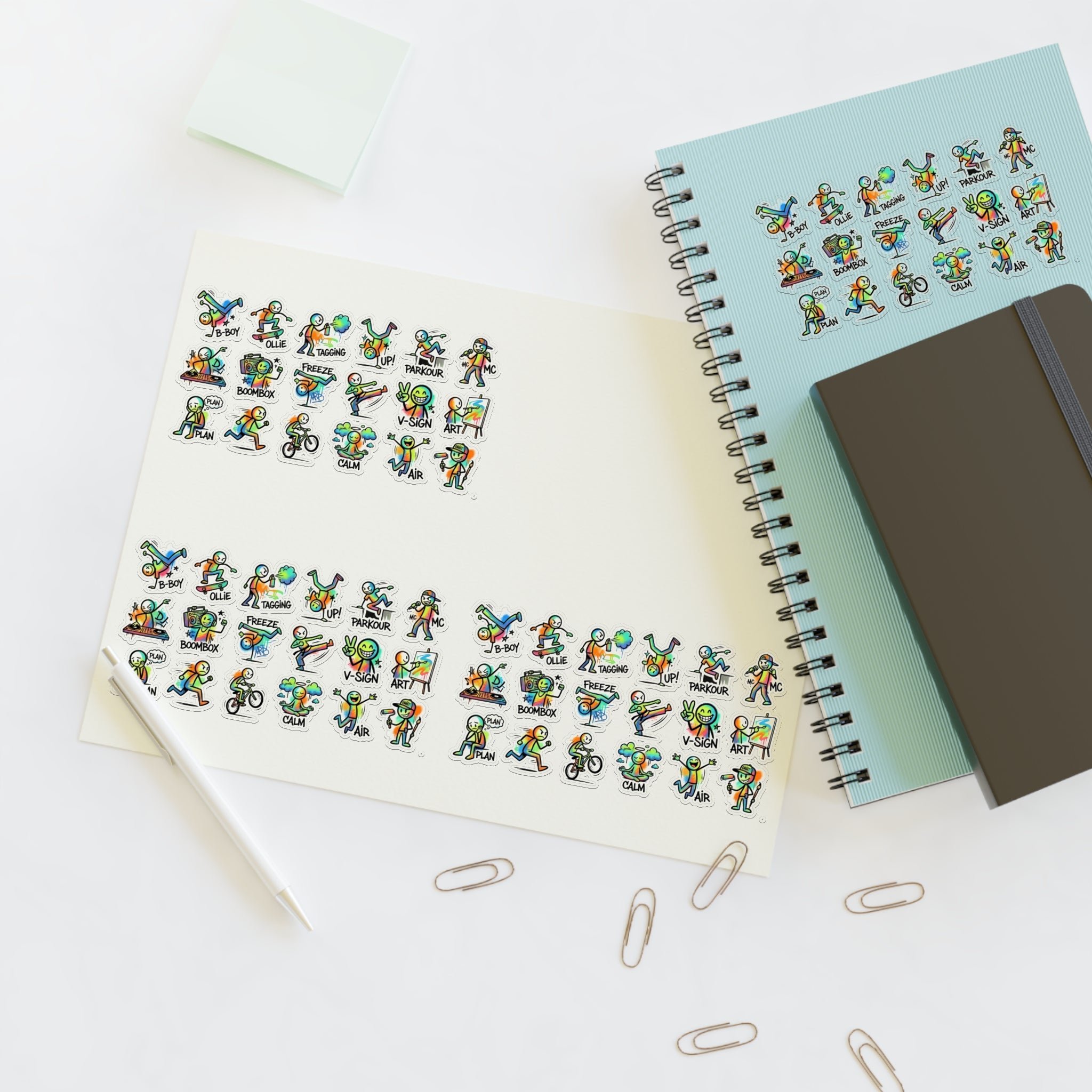 Cute character sticker sheet with die-cut activity icons, placed beside a notebook
