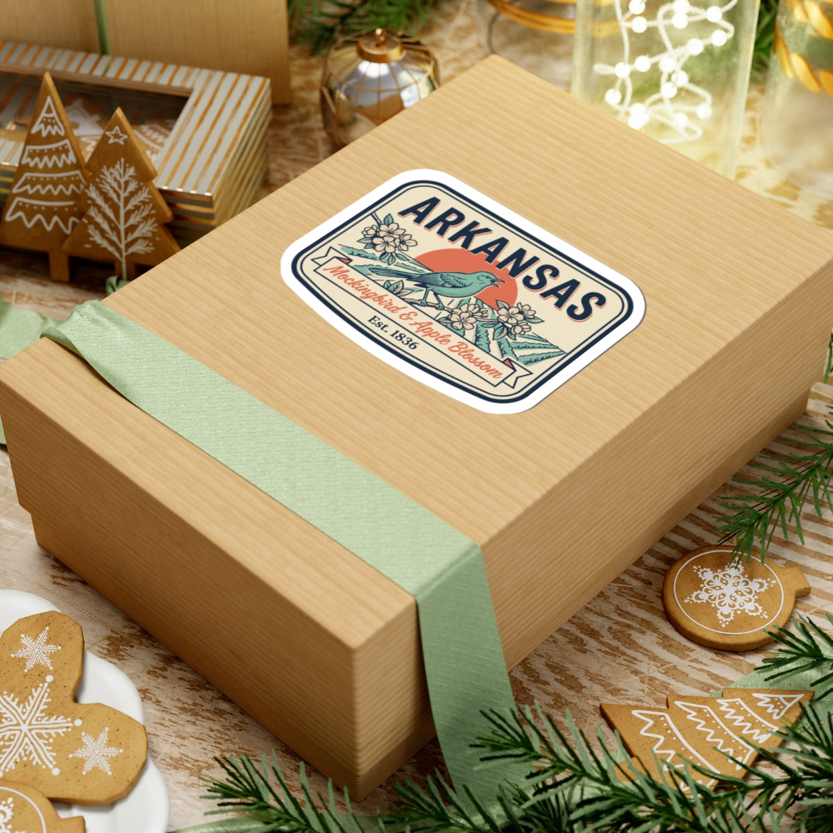 Arkansas state badge sticker on a wrapped wooden gift box with blue bird and flowers