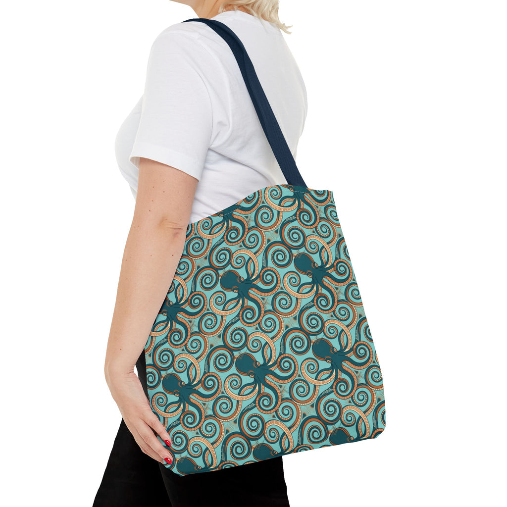Teal octopus swirl tote bag with navy strap, side view of all-over pattern.