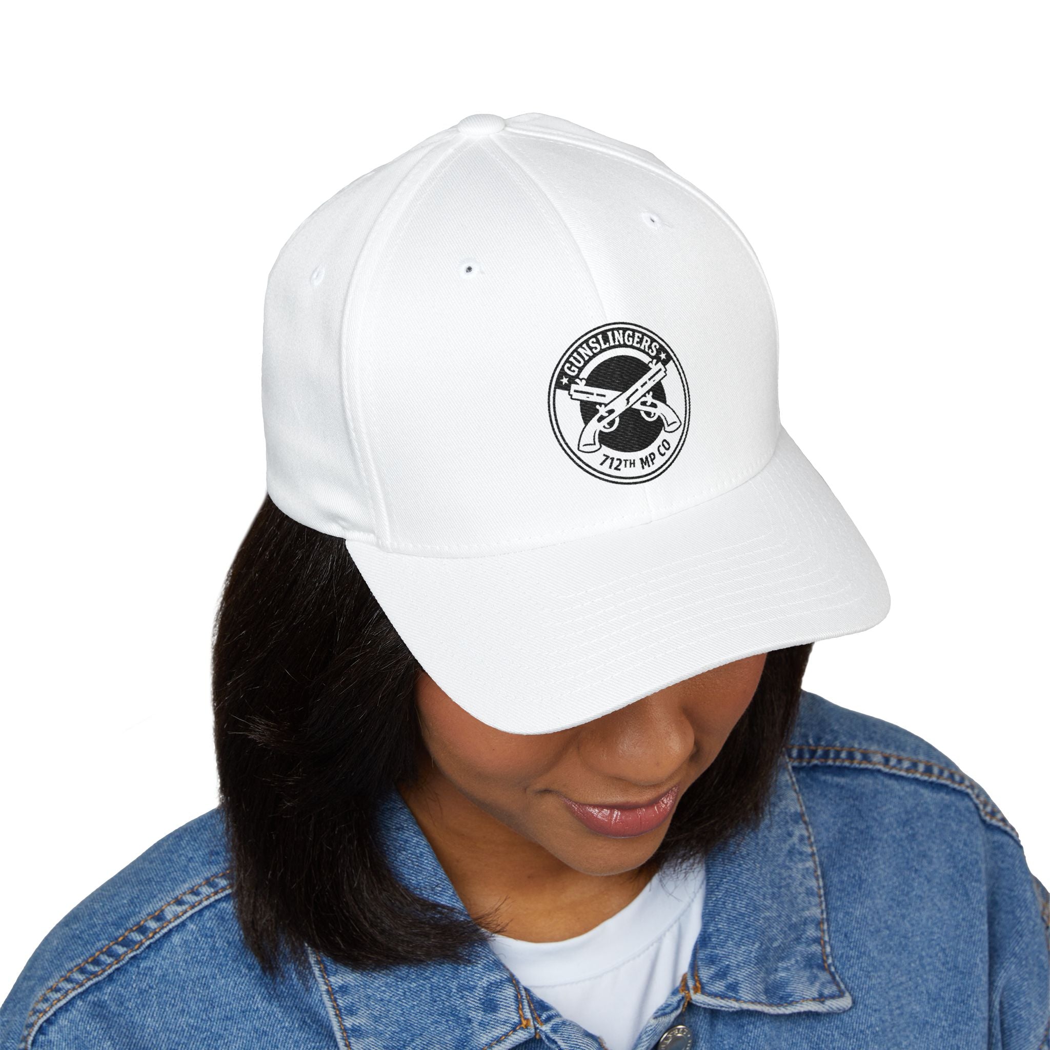 White embroidered baseball cap with black circular emblem on front