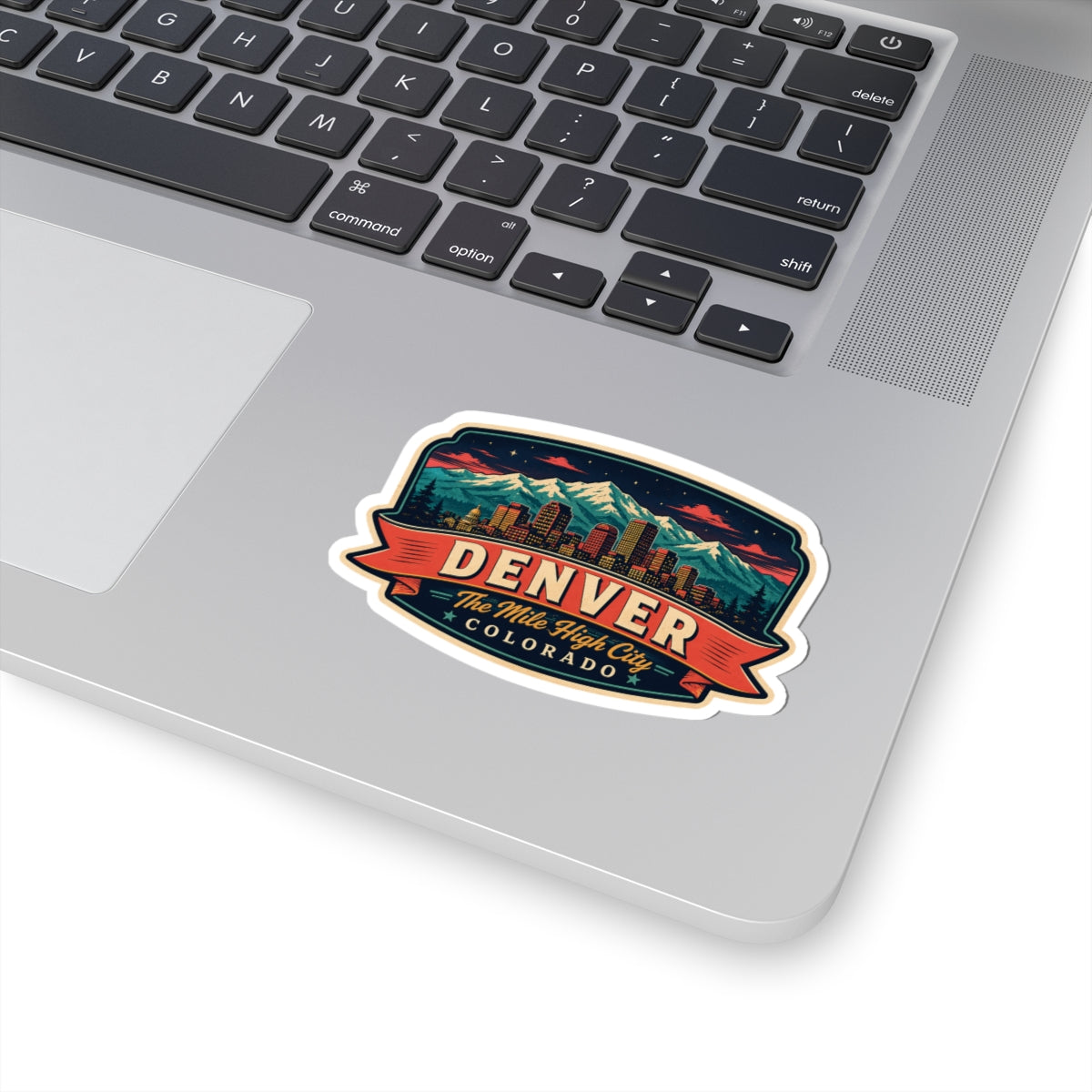 Luggage tag sticker on laptop with Denver skyline and “The Mile High City Colorado”