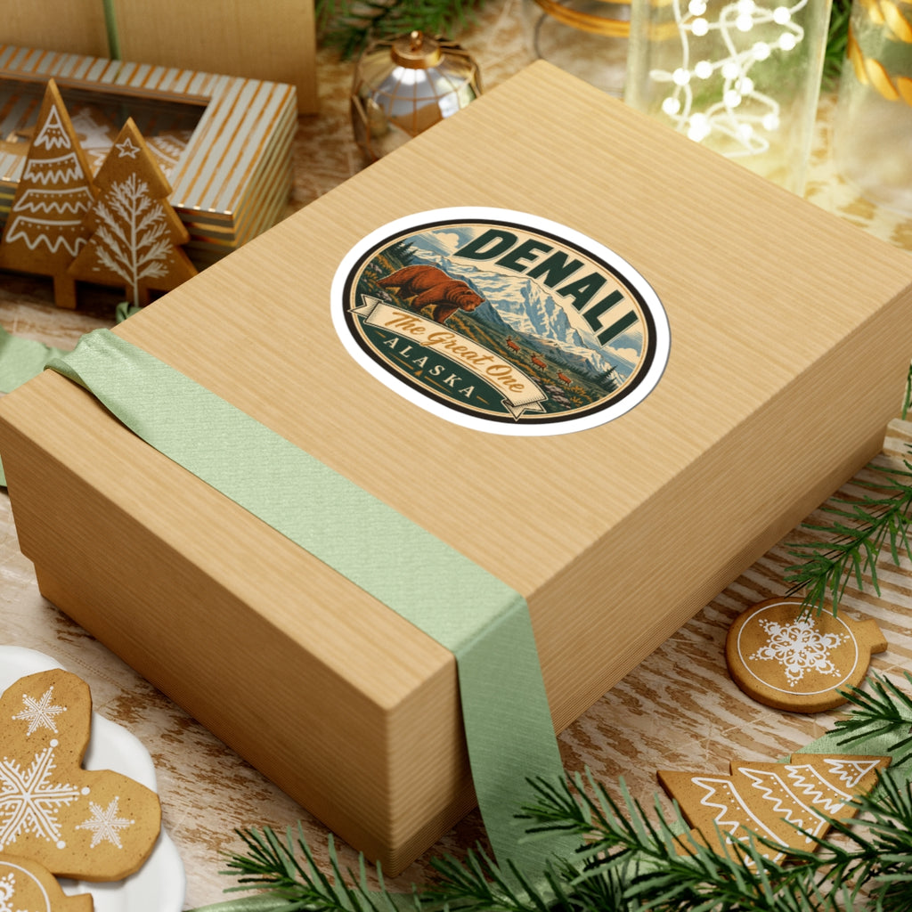 Denali oval sticker on a wooden gift box with green ribbon, bear and “The Great One Alaska”