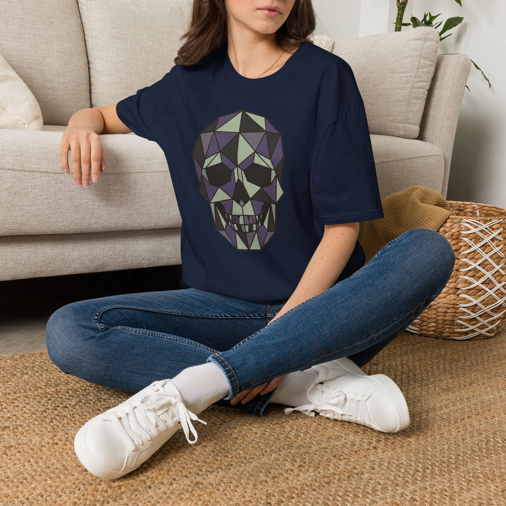 Navy T-shirt with purple geometric skull graphic on front, worn seated