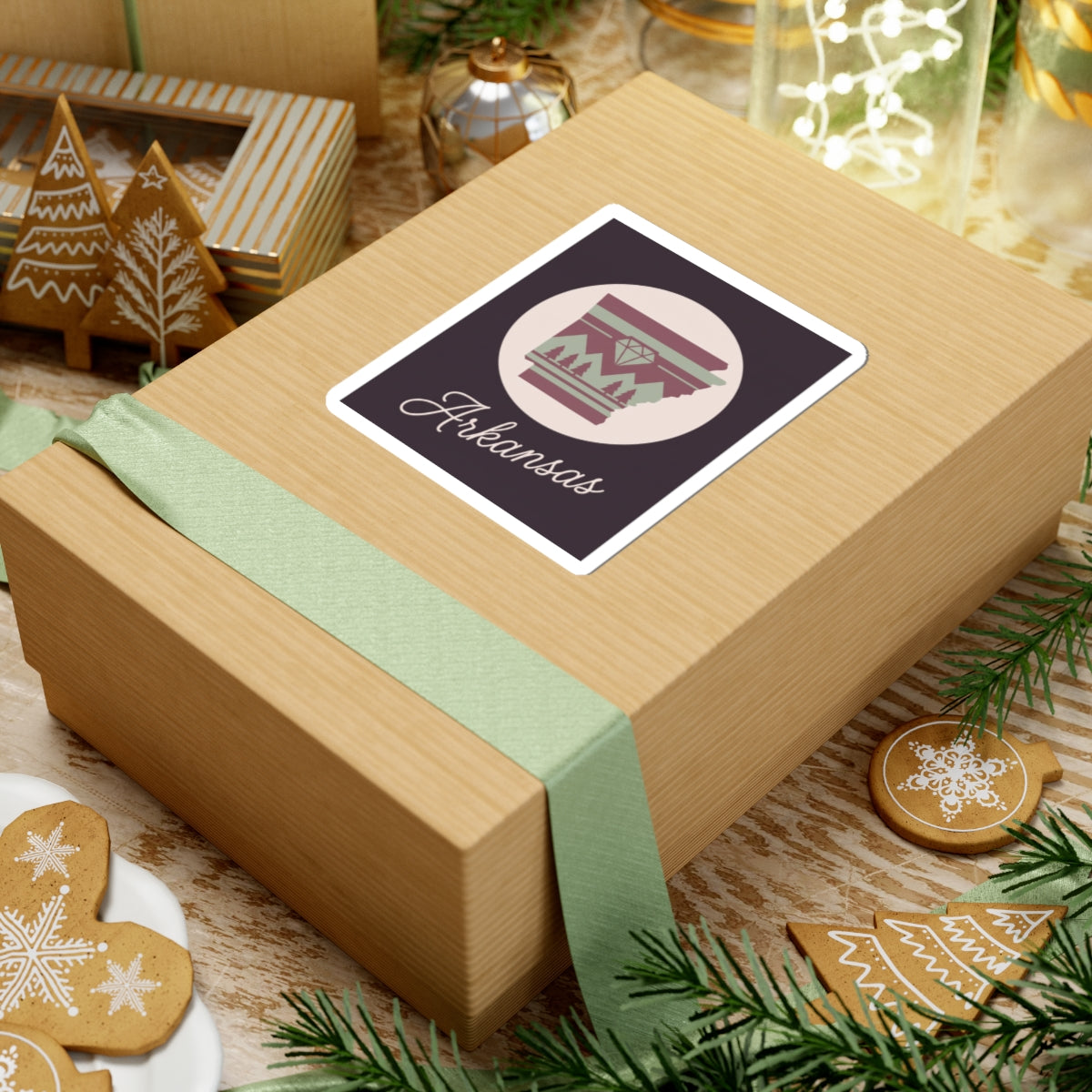 Arkansas state vinyl sticker on wrapped gift, circular maroon emblem with 'Arkansas' text