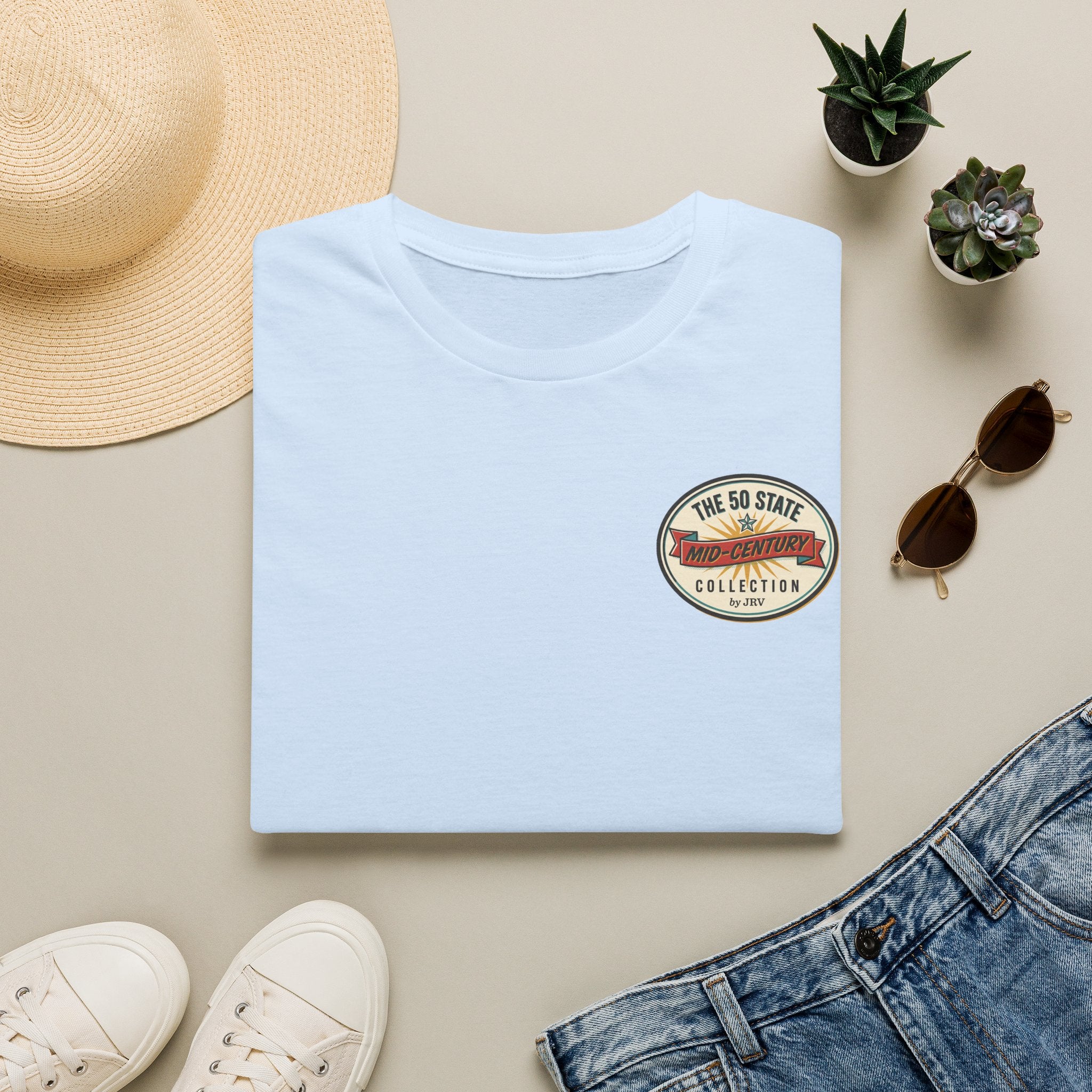 Light blue crew-neck T-shirt with round badge graphic on the front chest