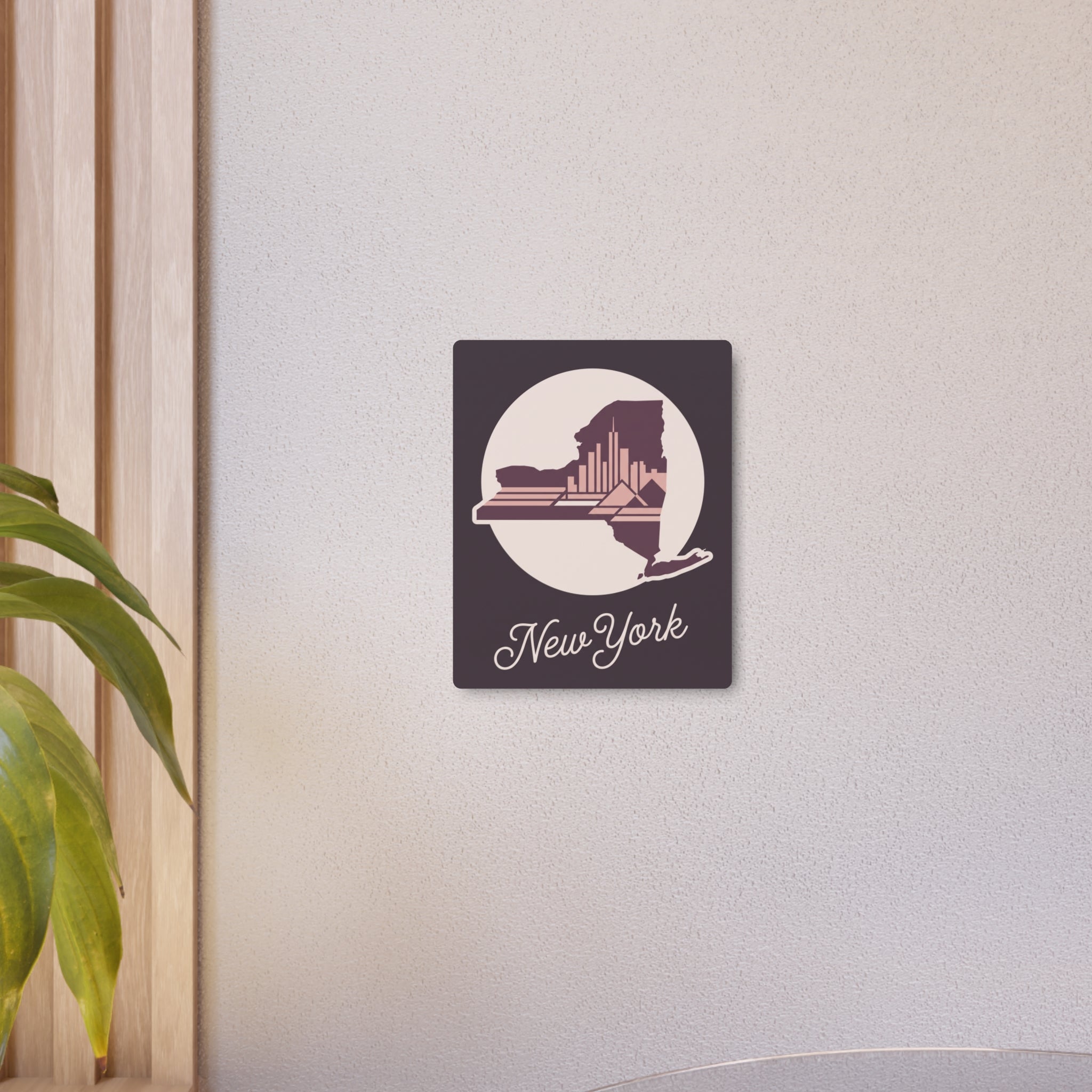 Mauve-toned square metal wall art with circular New York skyline silhouette and script “New York”.