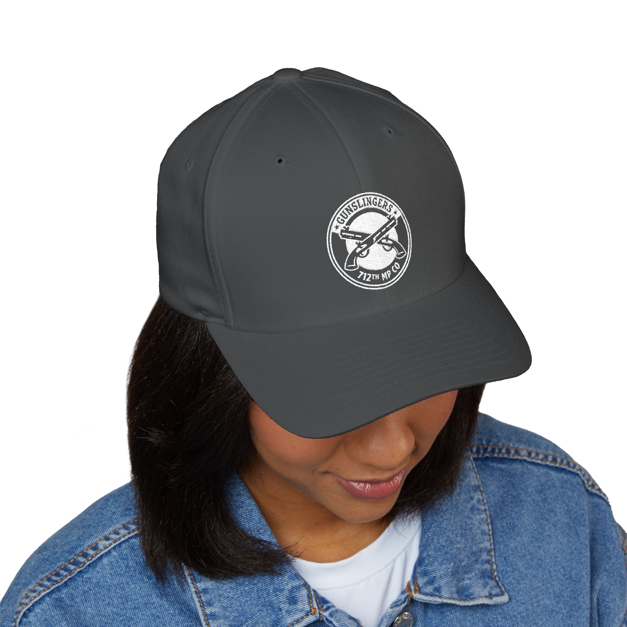Embroidered baseball cap in dark gray/black with round white emblem on front