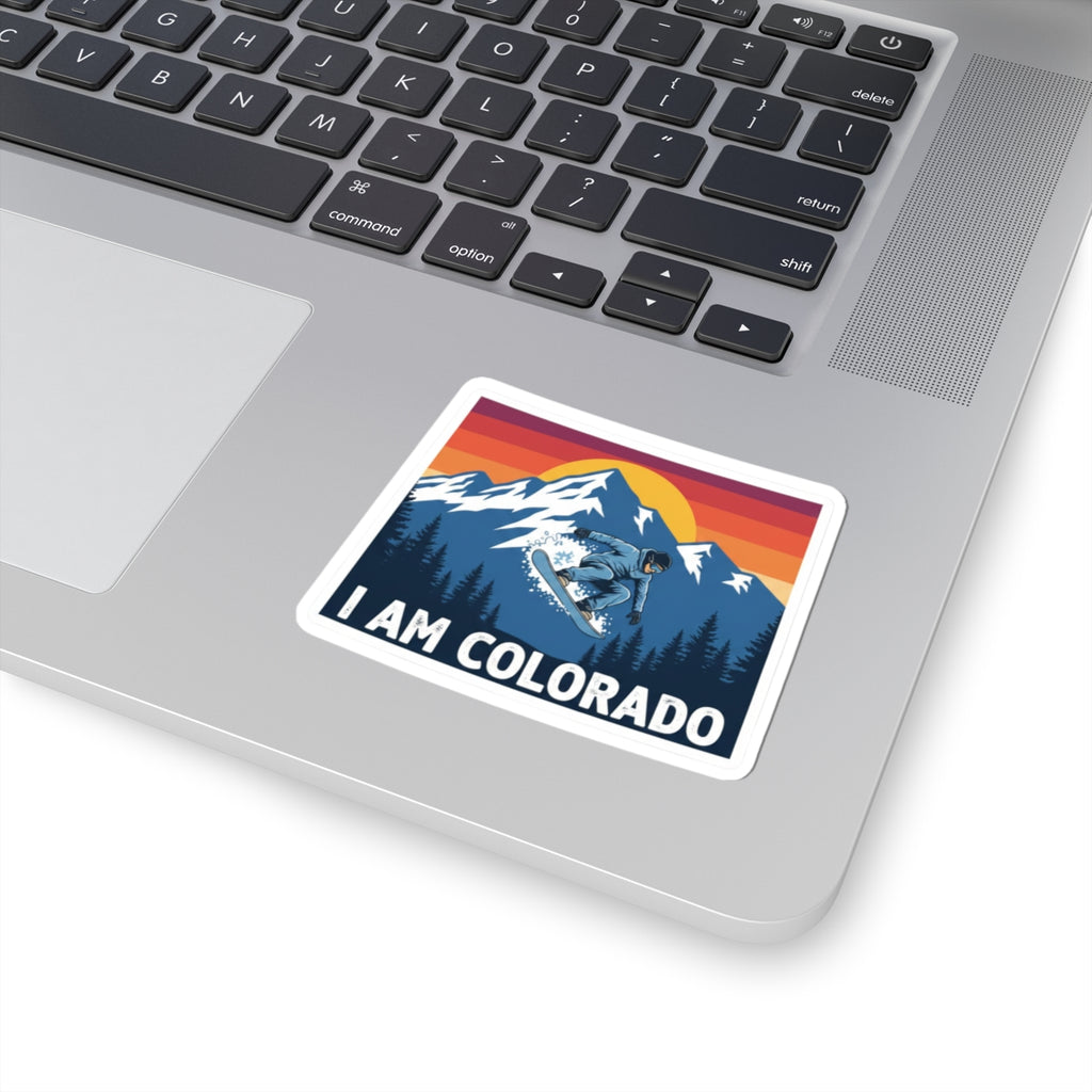 I Am Colorado sticker on laptop, snowboarder scene with pine trees and “I AM COLORADO”