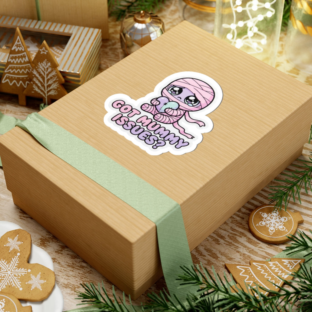 Chibi baby mummy sticker with heart, pink hood, “GOT MUMMY ISSUES?” purple text