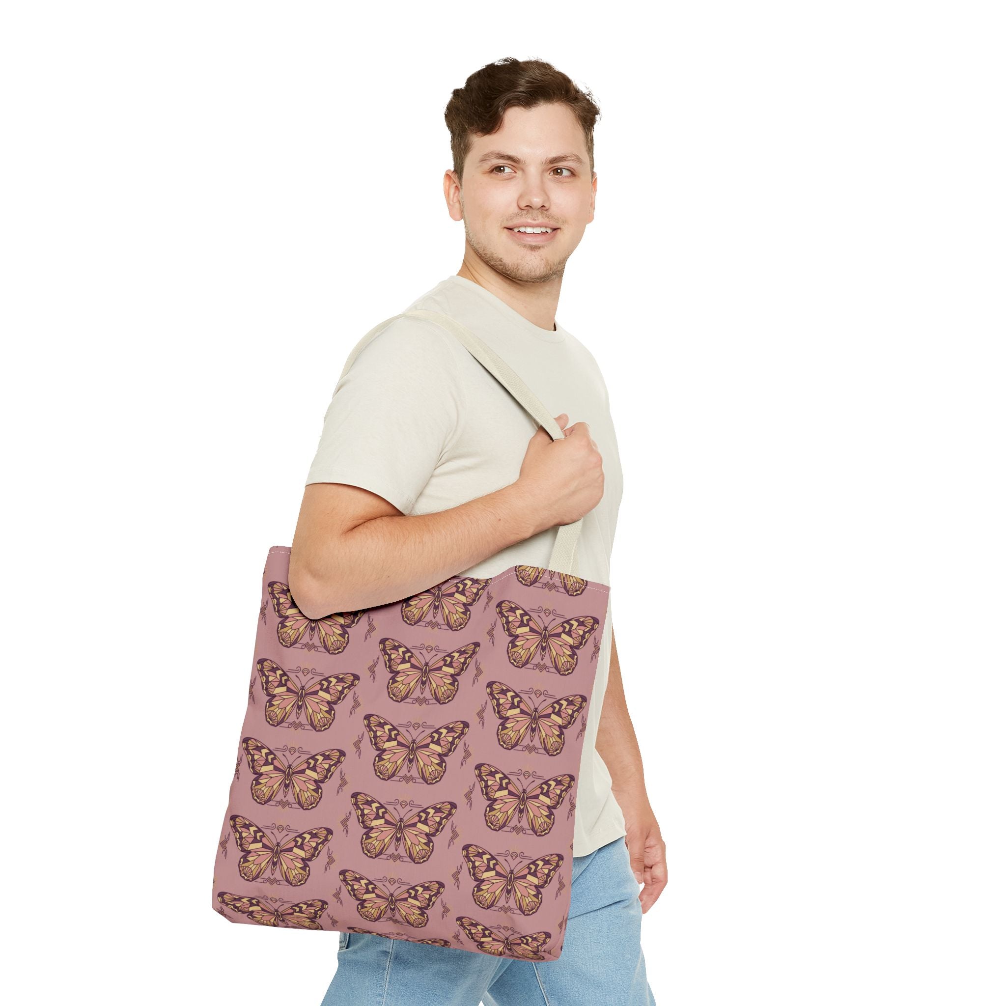 Pink butterfly tote bag with light beige handles, held on the shoulder