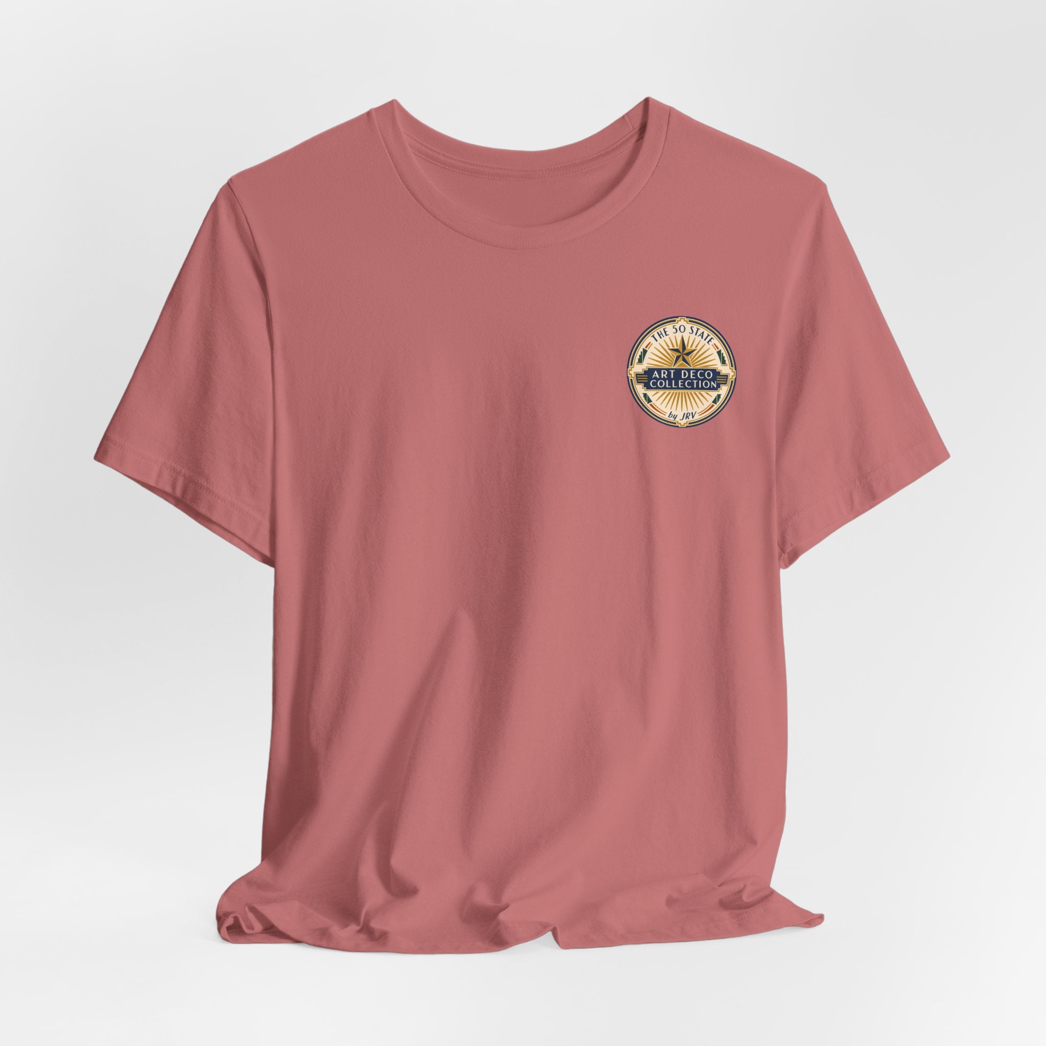 Dusty rose crew-neck T-shirt with round logo patch graphic on left chest.