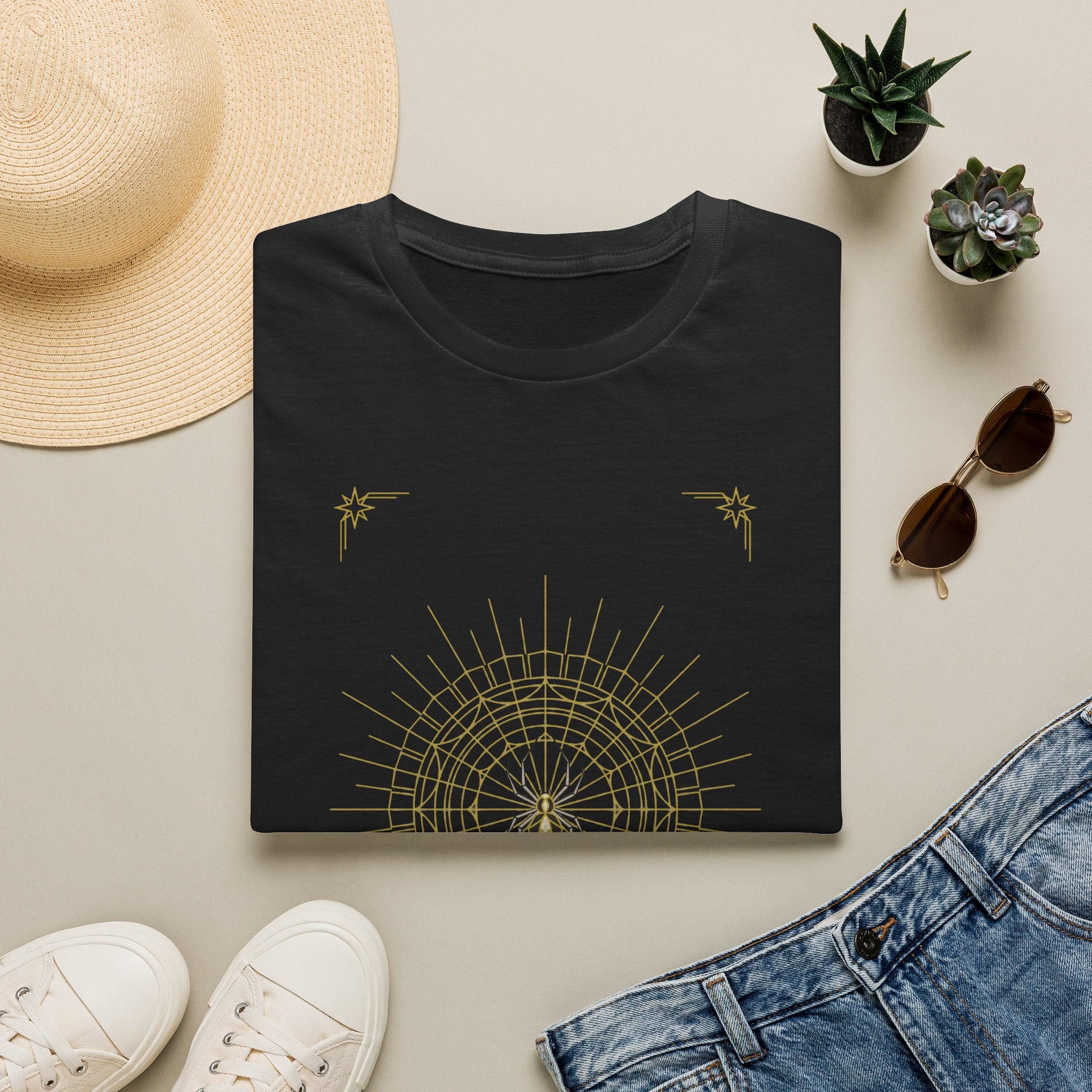 Black T-shirt with gold spider web mandala and small star accents on the chest
