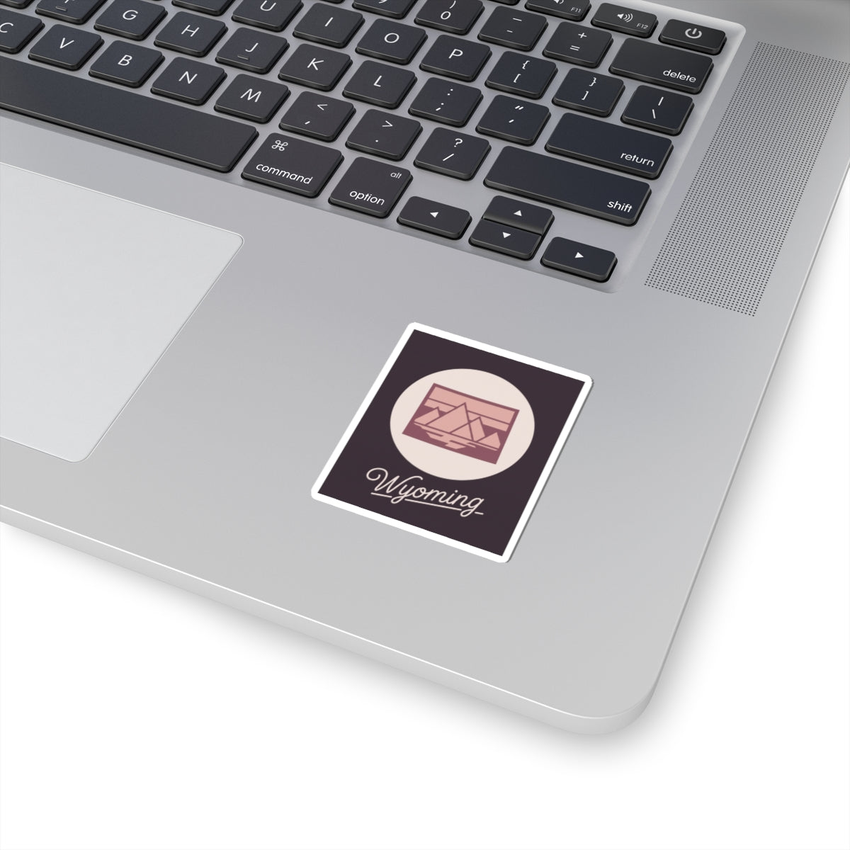 Wyoming state silhouette kiss-cut decal sticker with mountain icon and script 'Wyoming'