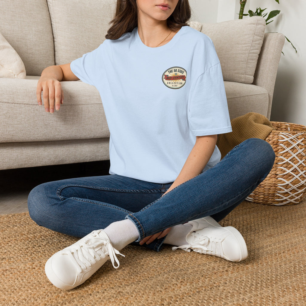 Light blue crewneck t-shirt with small circular chest badge logo