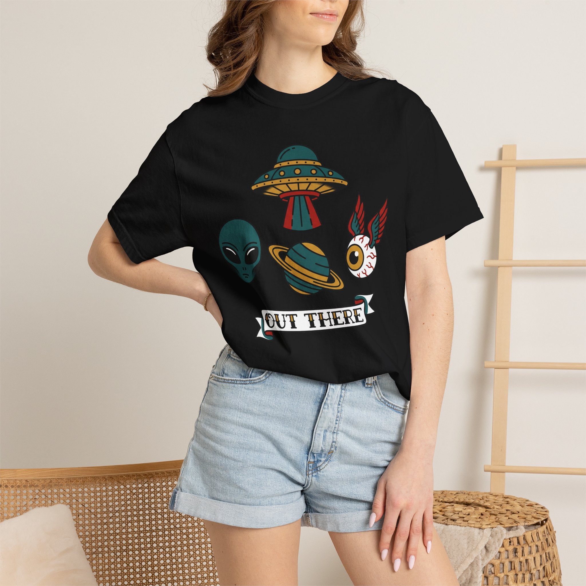Black T-shirt on model with alien, UFO and space-cat graphic and OUT THERE label