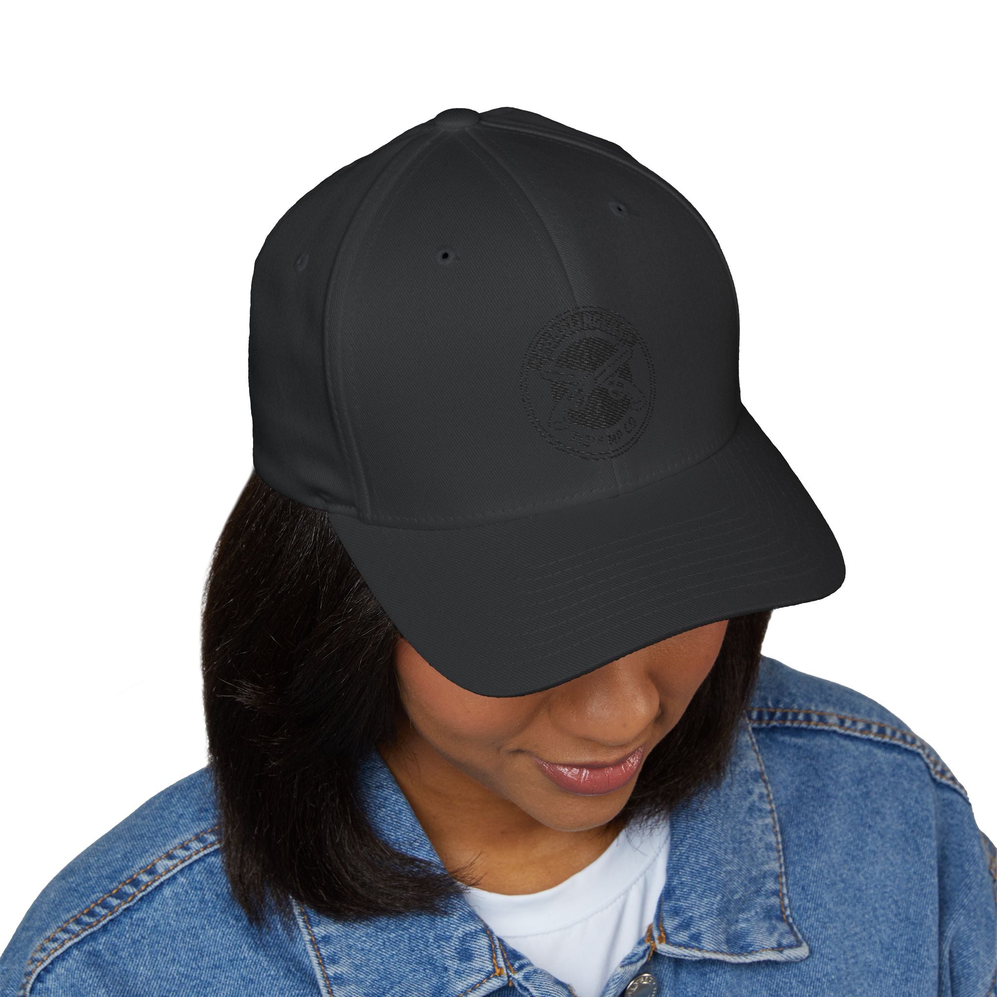 Embroidered military-style cap in dark grey with circular top emblem