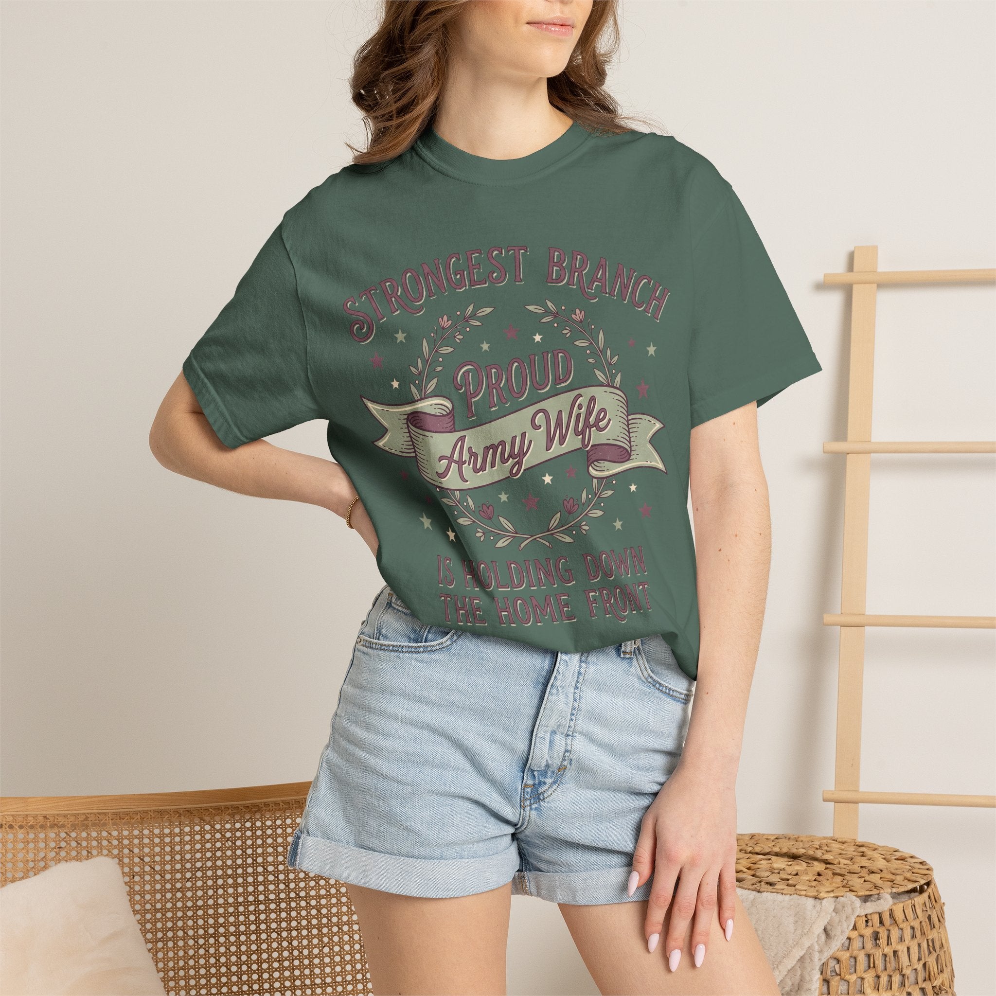 Green T-shirt worn by a model; wreath and banner print plus text beneath.