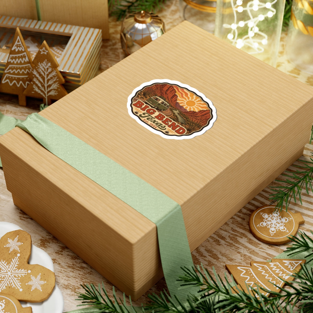 Die-cut road trip sticker on a gift box showing Big Bend Texas desert cliffs and vintage camper