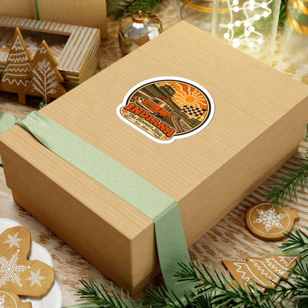 Round vintage van decal on a wrapped gift box with orange sunburst, checkered flag, Indiana