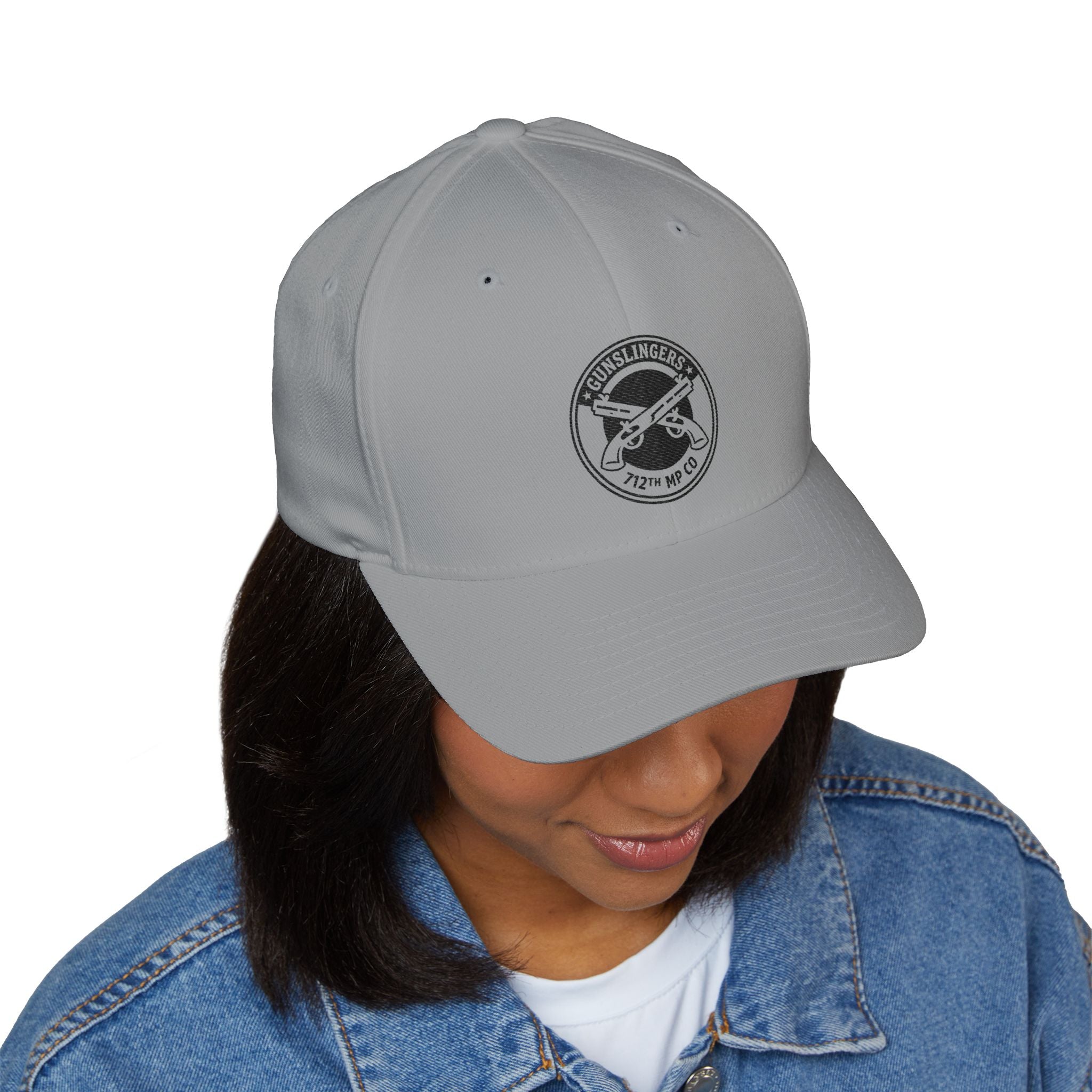 Light gray baseball cap with circular black embroidered emblem