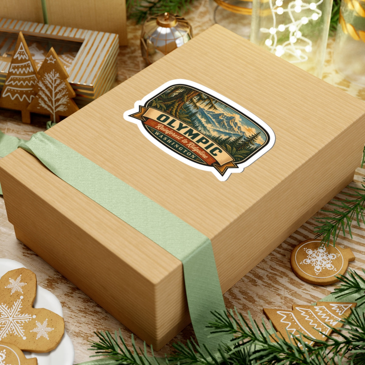 Olympic Washington sticker on a gift package with green ribbon, showing forest and mountain graphic
