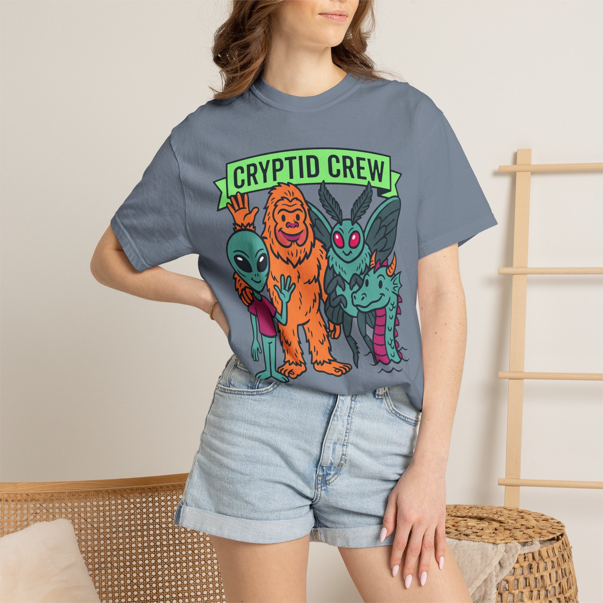 Slate blue crewneck T-shirt on model with Cryptid Crew graphic