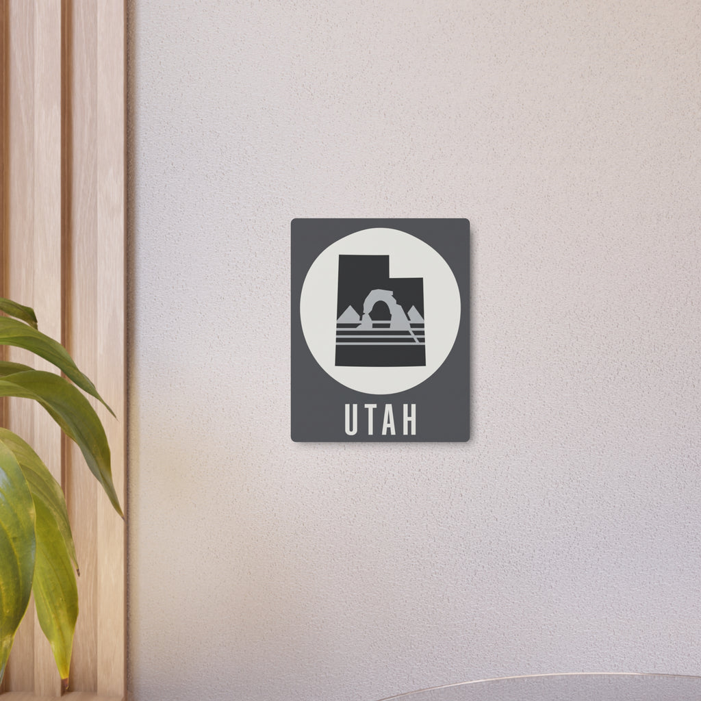 Utah metal wall art sign mounted on wall, dark square with white circle and mountain silhouette