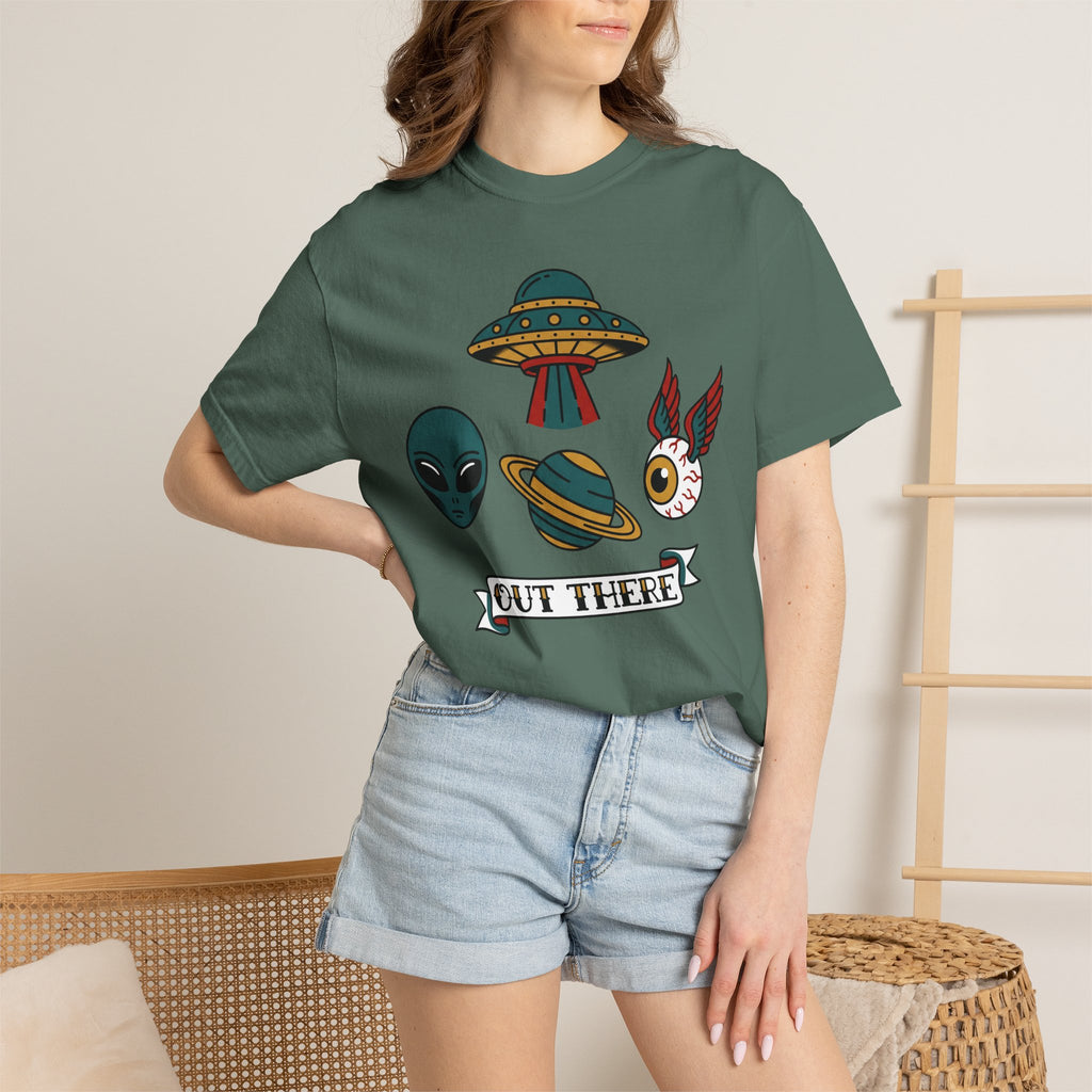 Green crewneck T-shirt with UFO and alien patch graphic, worn with denim shorts.