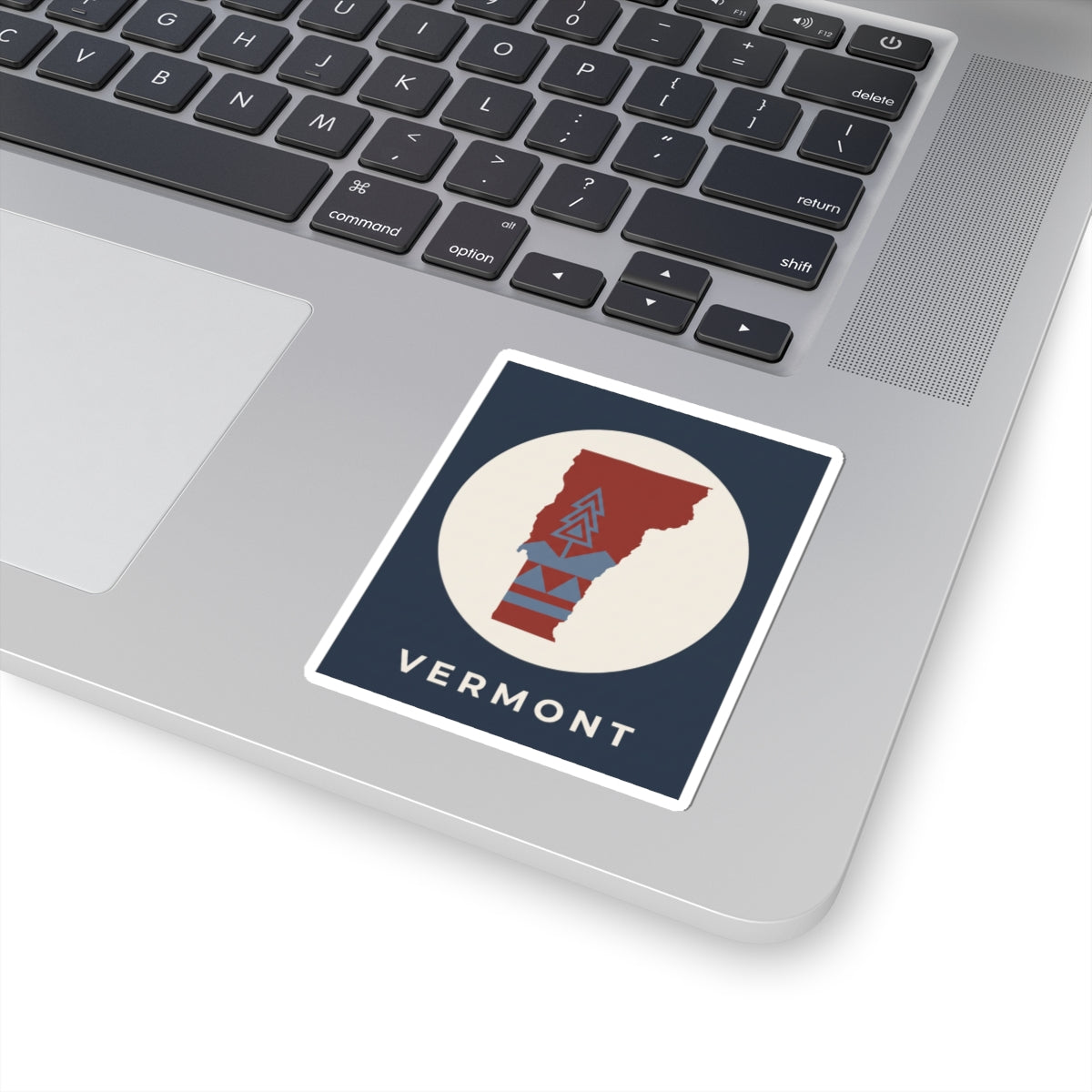 Vermont map sticker with navy frame, beige circle, red state and blue mountain artwork, 'VERMONT'