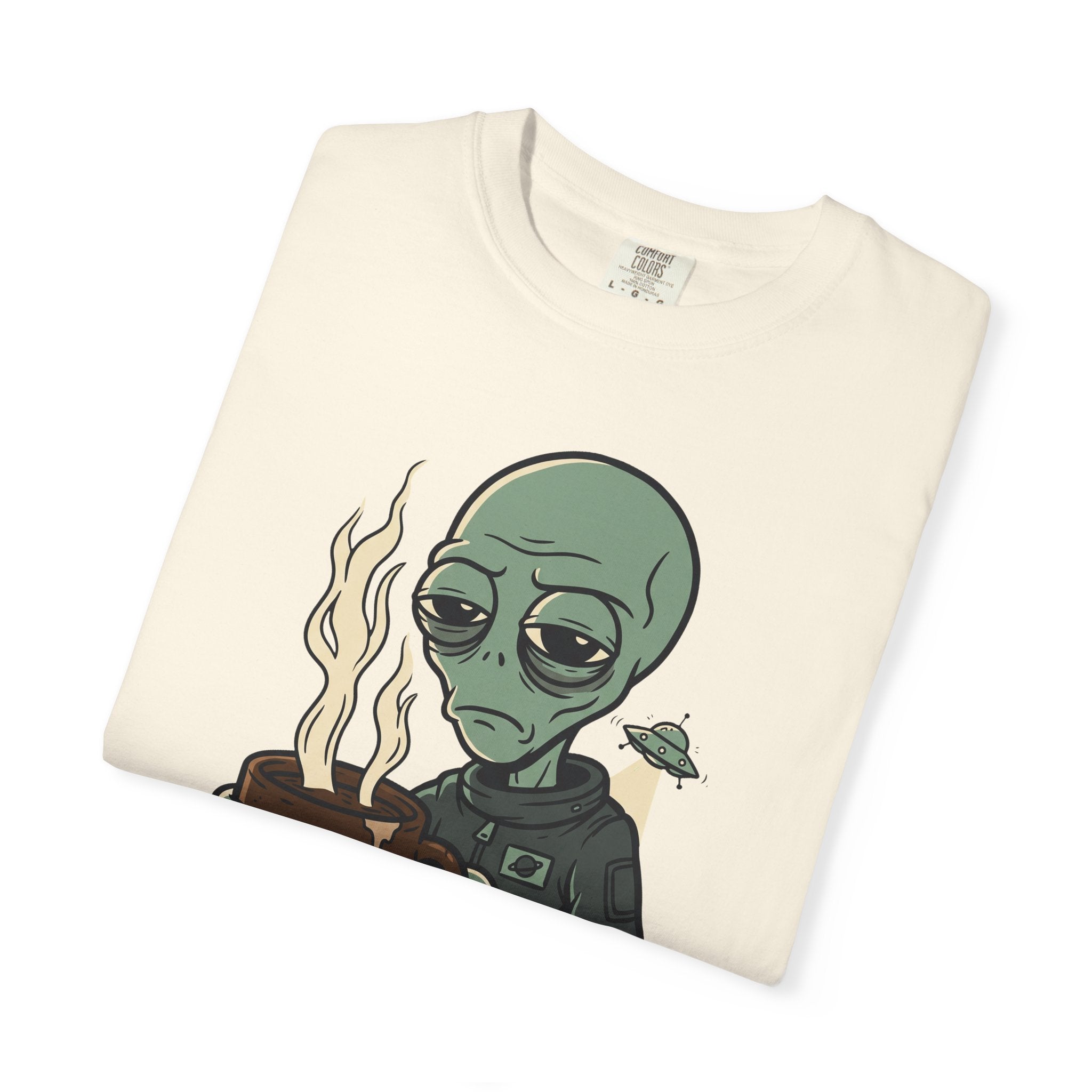 Ivory crew-neck T-shirt with alien holding coffee and small spaceship graphic.