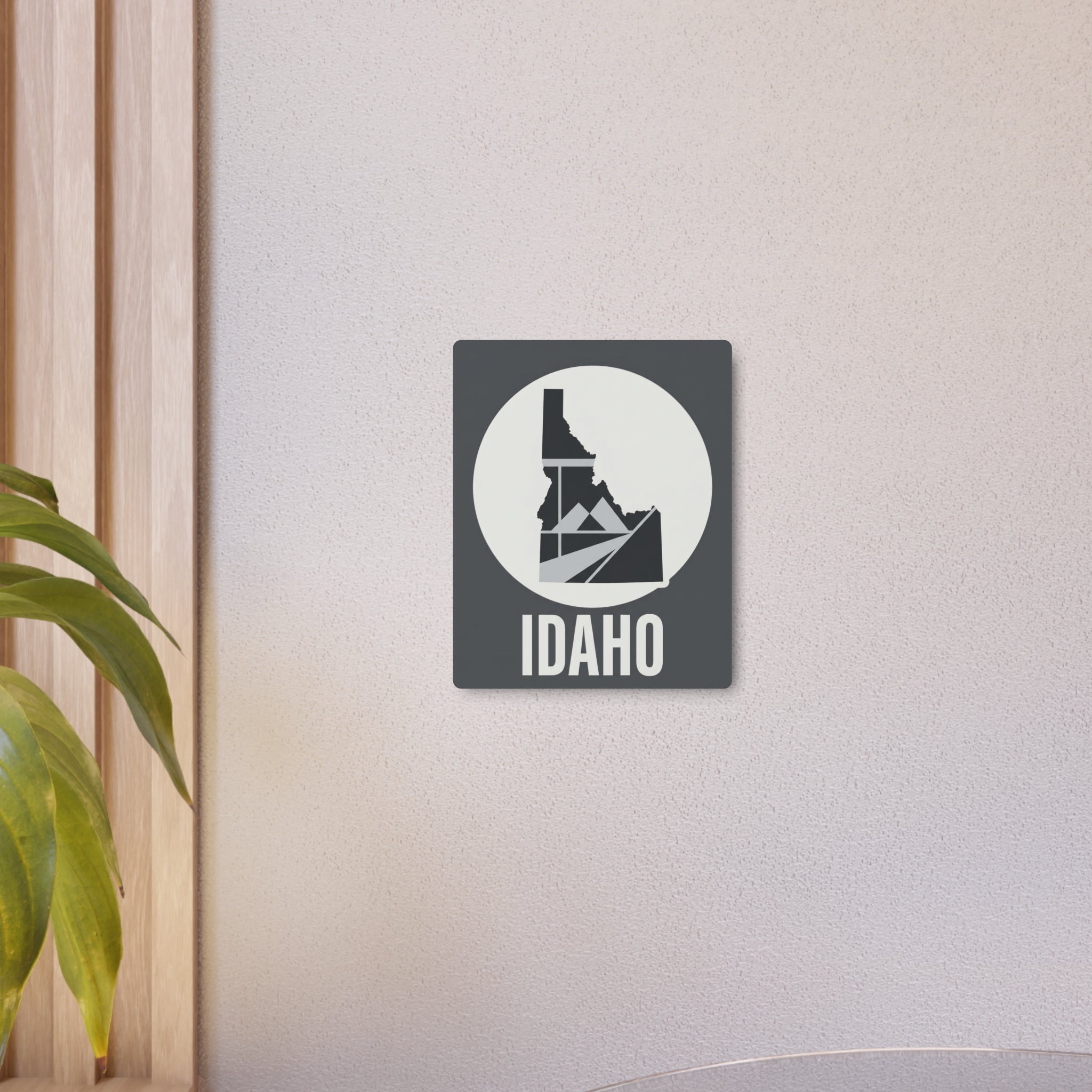 Idaho metal wall art sign featuring circular state emblem and "IDAHO" word