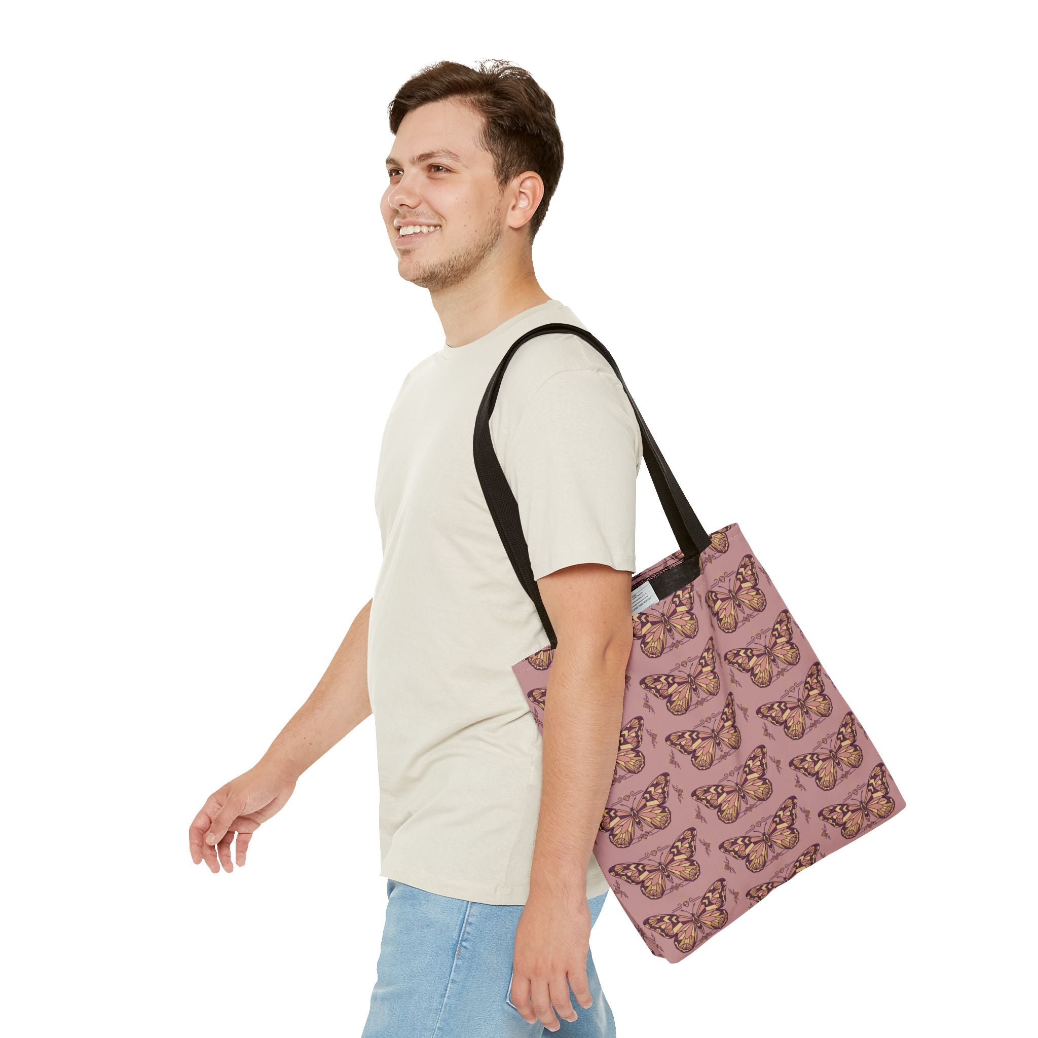 Pink butterfly-pattern tote bag with black straps worn over the shoulder