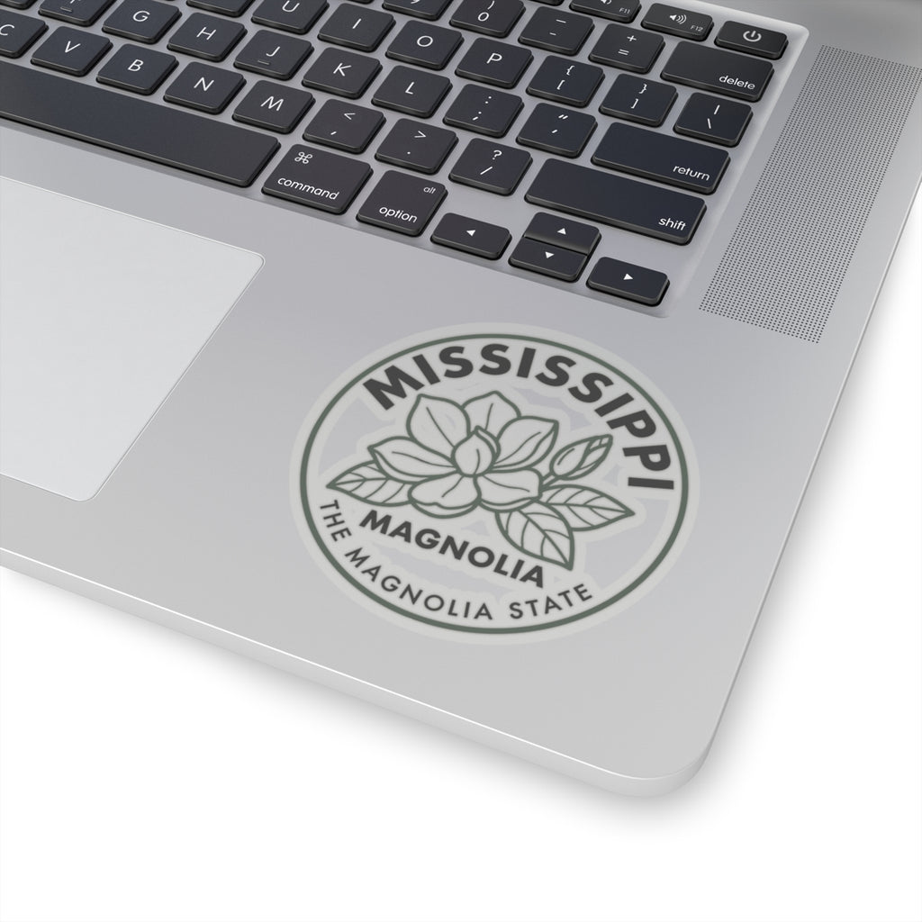 Transparent vinyl sticker on a laptop screen corner with Mississippi magnolia state seal